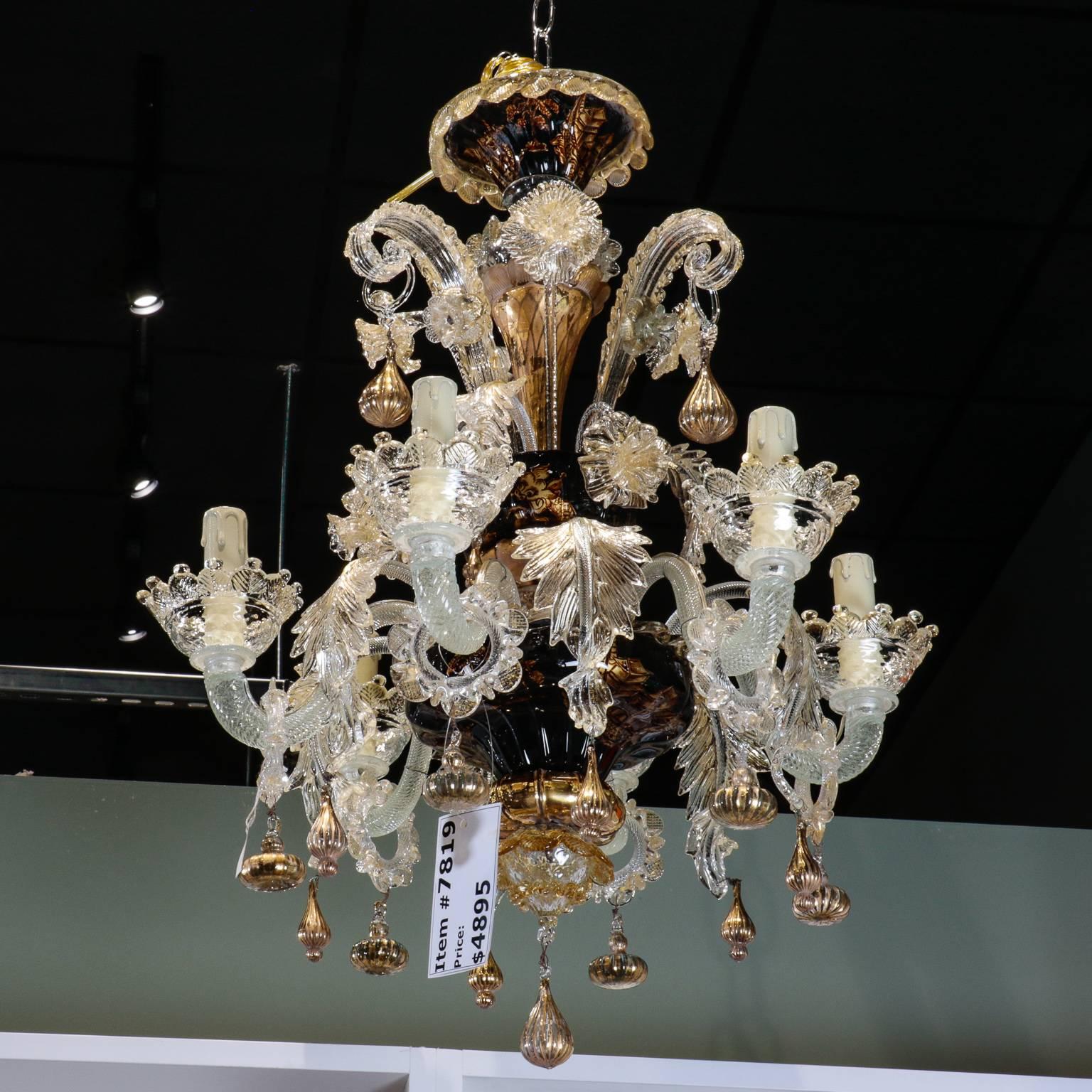 Venetian six-light chandelier in clear handblown glass accented with gold inclusion (gold dust) glass on bobeches, hanging tassel forms, leaves and ornamental pieces. Center support and canopy features hand blown glass bowls with Chinese motif
