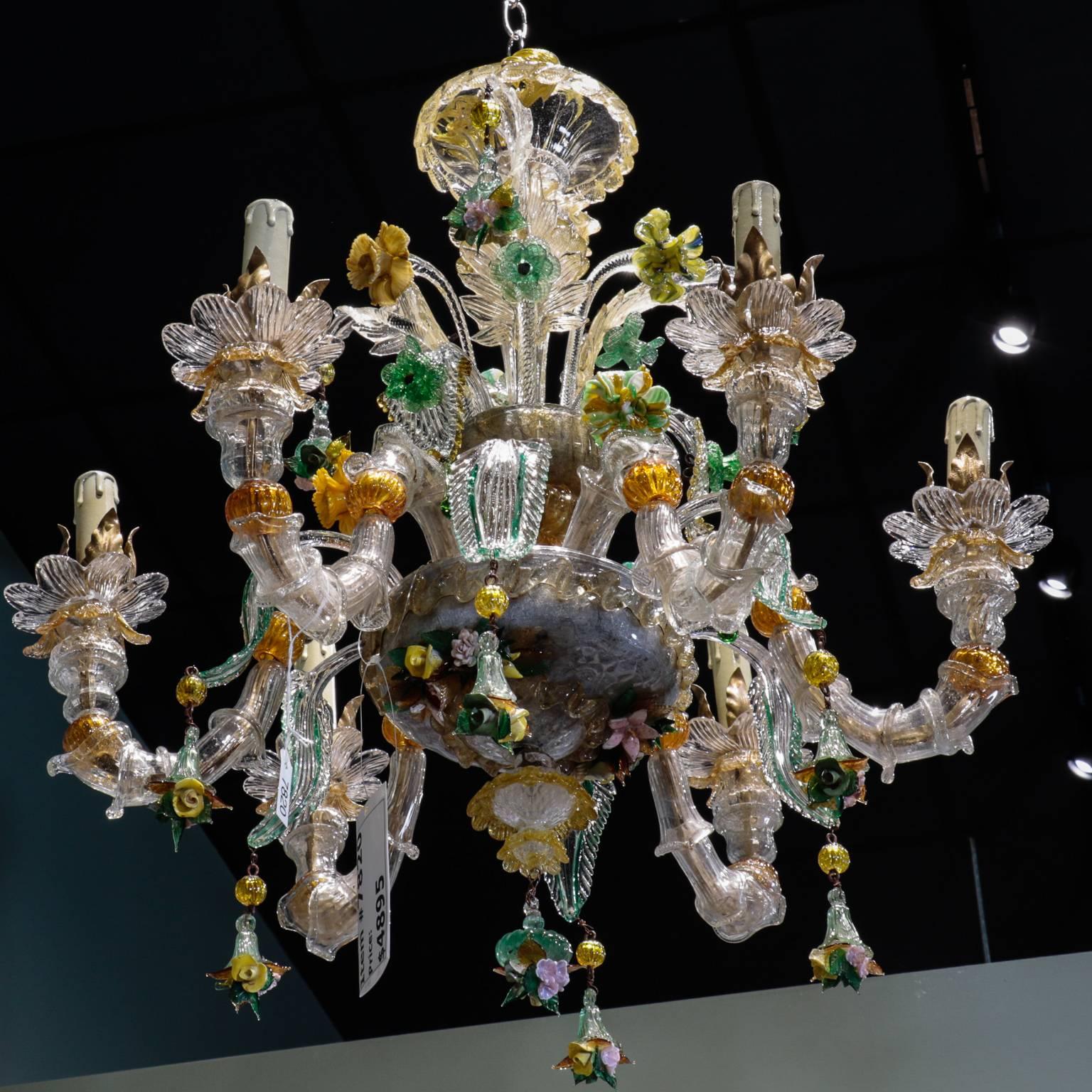Circa 1880s Venetian chandelier features clear hand blown glass foundation with gilt metal bobeches, multicolor and gold dust glass accents. Large glass blown leaves and colored glass flowers along decorate the six light chandelier along with