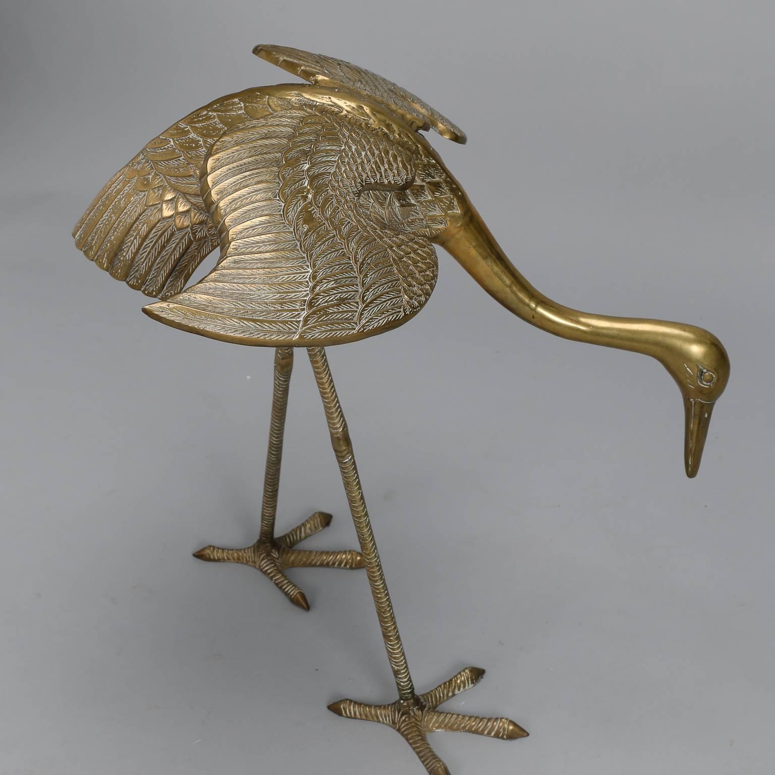 This pair of circa 1960s cast brass crane or heron sculptures is just under 40” tall. Rendered in fine detail, each bird stands on its own and can be displayed separately or together as a pair. Unknown origin - found in Italy. Measurements shown are