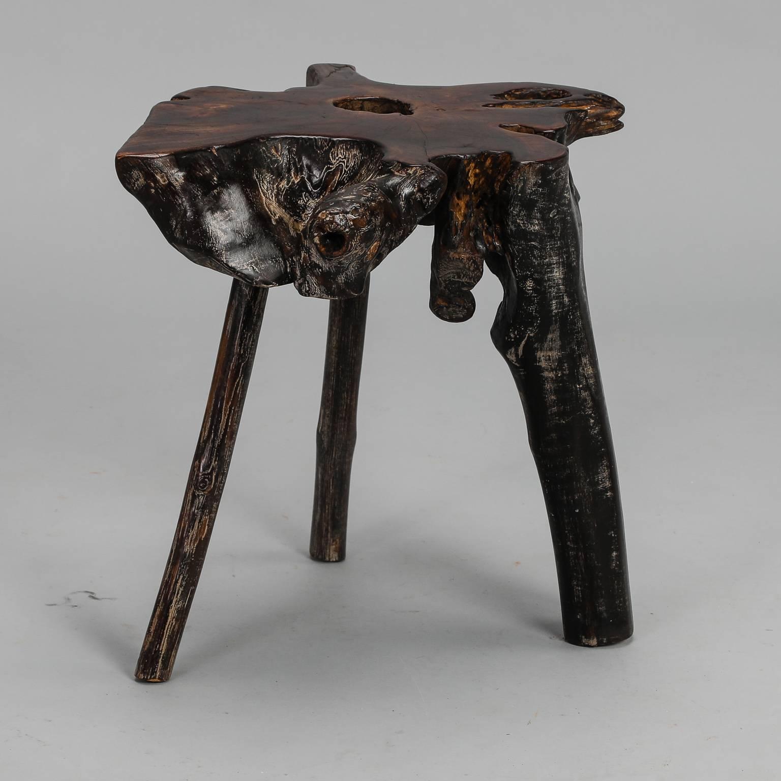 Chinese side table made from root ball of a tree dates from approximately 1960. Organically shaped table top has a hole in it where roots separate. Legs are natural form roots and all have been sanded, stained and sealed. One other similar table