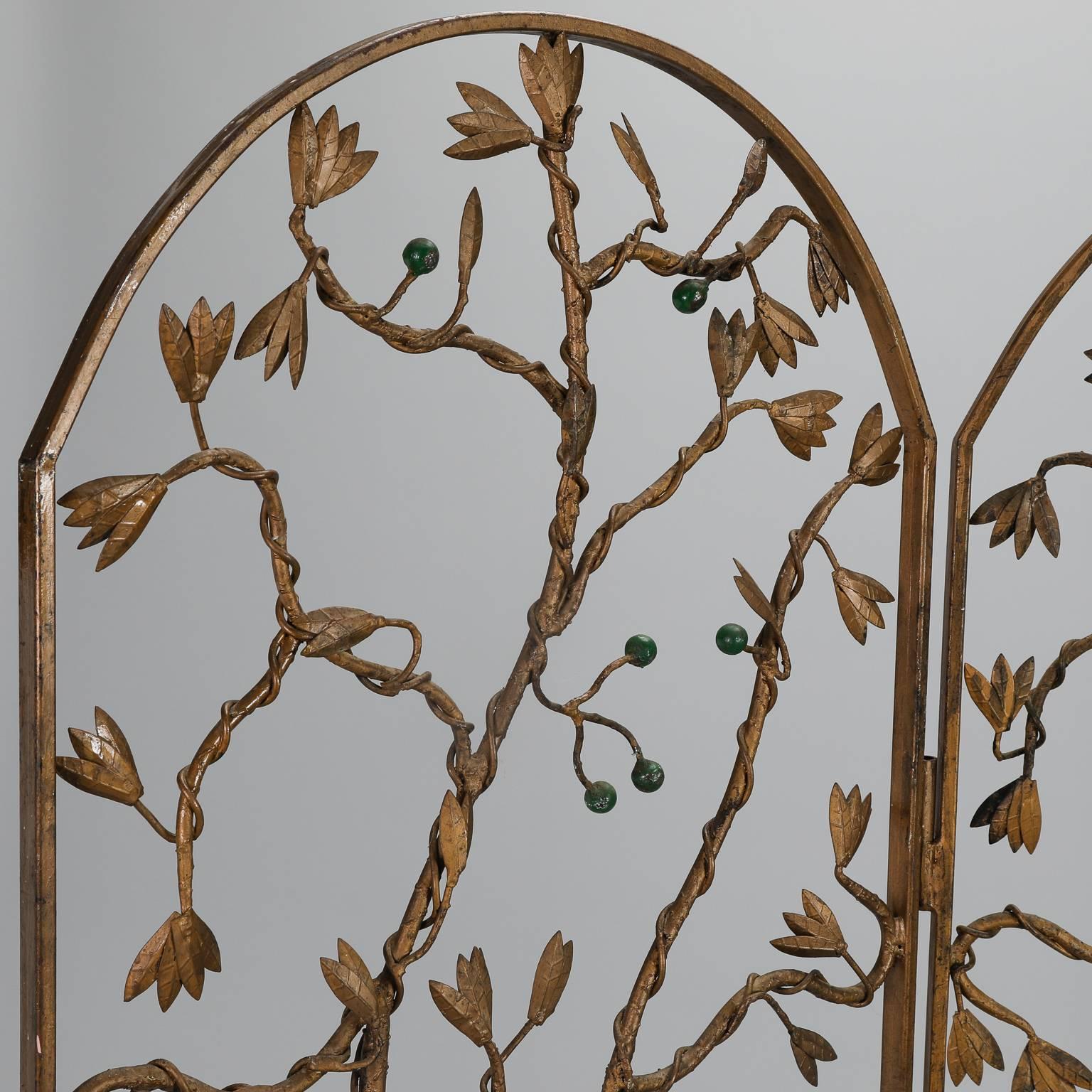 Found in Italy, this circa 1950s metal and iron floor screen has three arched panels with open work vine and berry design. Frame, twigs and leaves have gilded finish with green berries.