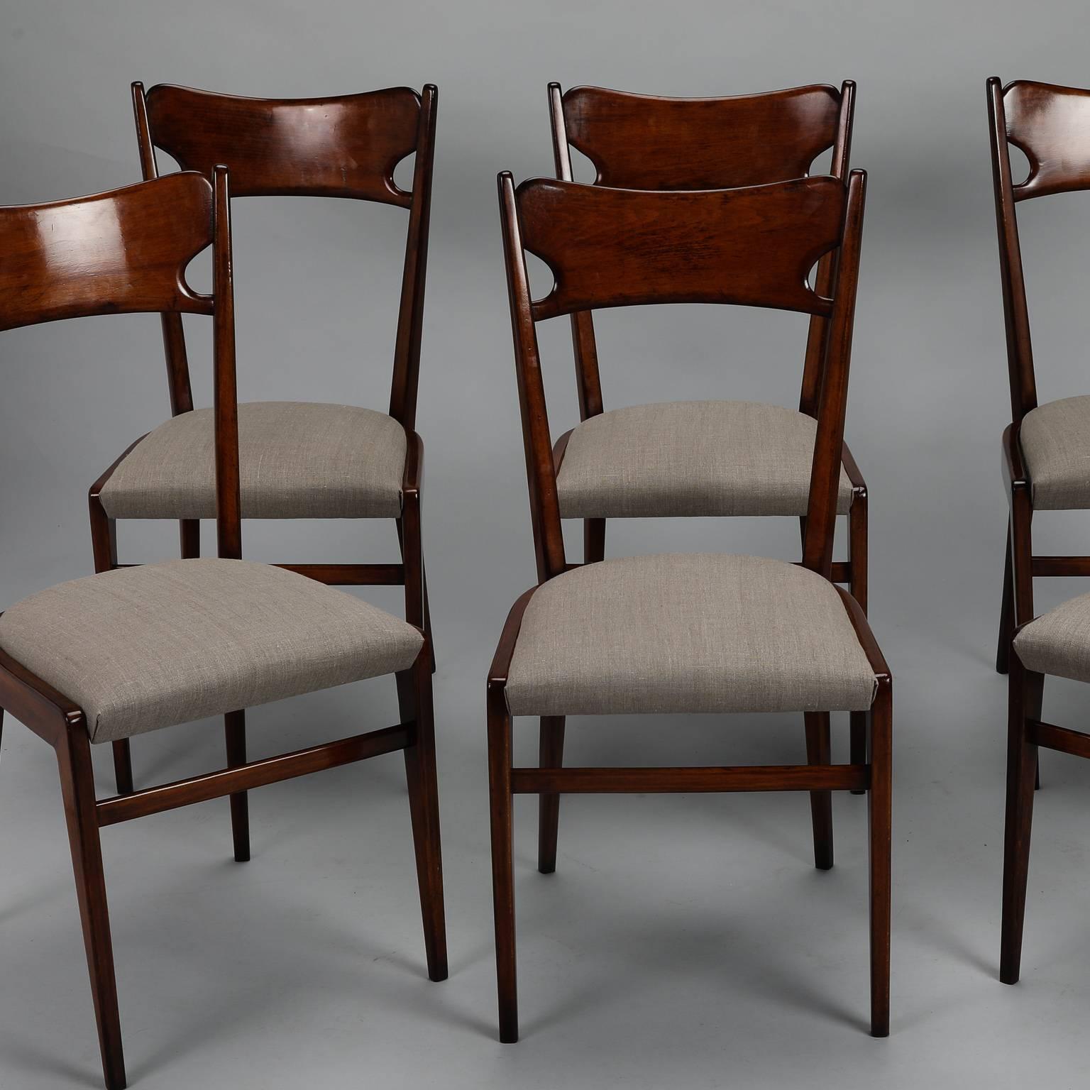 Set of six, circa 1960s Italian polished wood chairs with sleek lines, tapered legs and newly upholstered seats. Sold and priced as a set. Measures: Seats are 18.5” high and 17.25” deep. 

