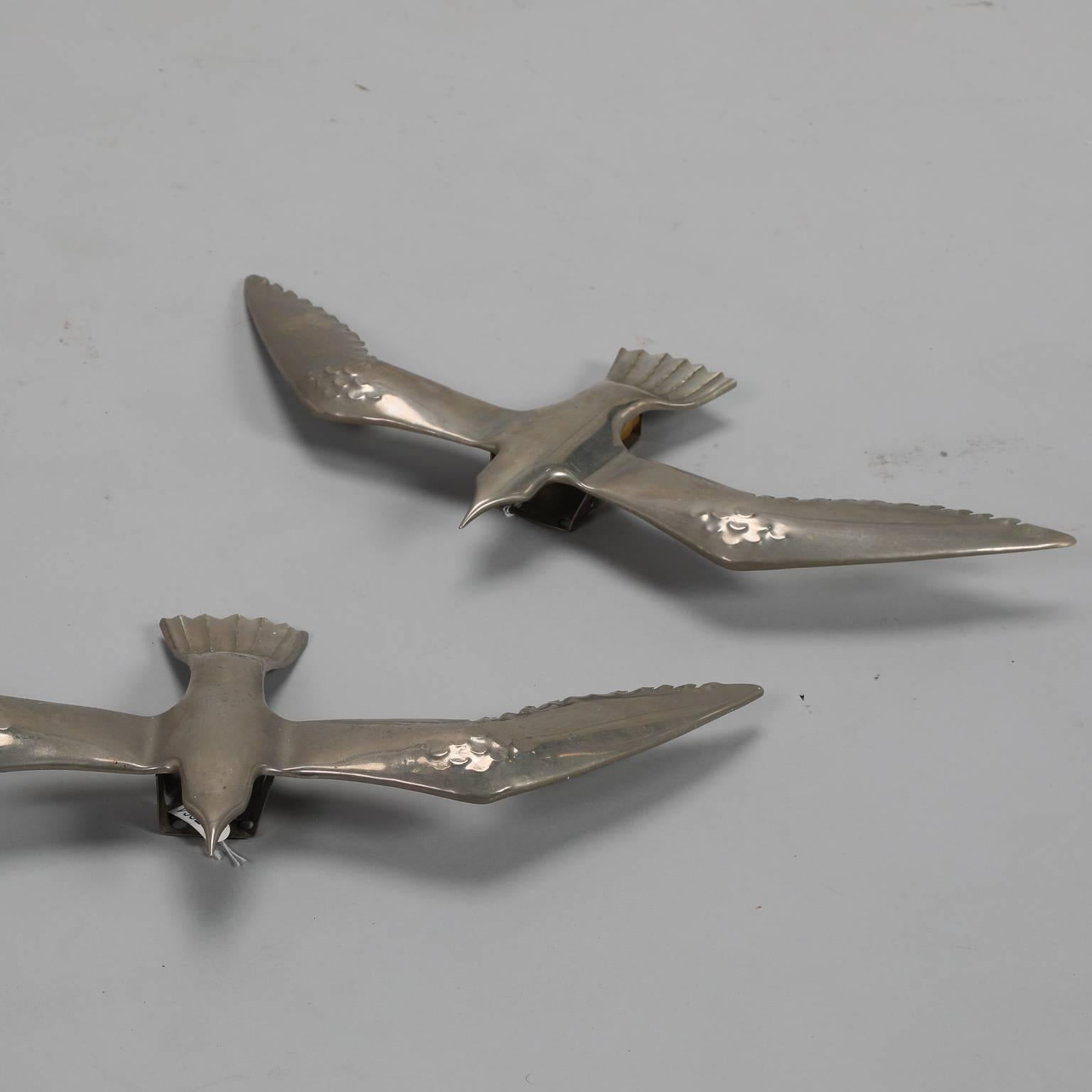 Found in Italy, this pair of circa 1970s cast aluminium seagulls can be used as wall sculptures or update the original electrical sockets for use as wall lights. Sold and priced as a pair. Similar styles in other sizes and brass finish also