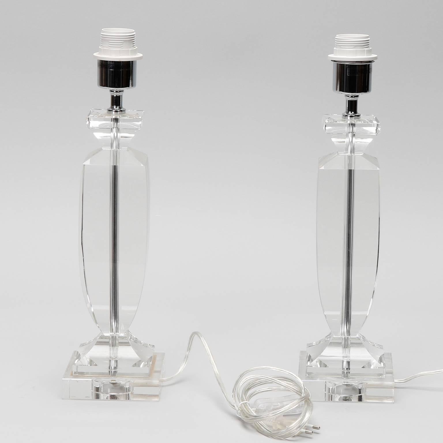 Pair of heavy clear Murano glass table lamps, circa 1990s. Glass is cut and faceted at base, center column and top. New electrical wiring for US standards. No maker’s marks found. Sold and priced as a pair.