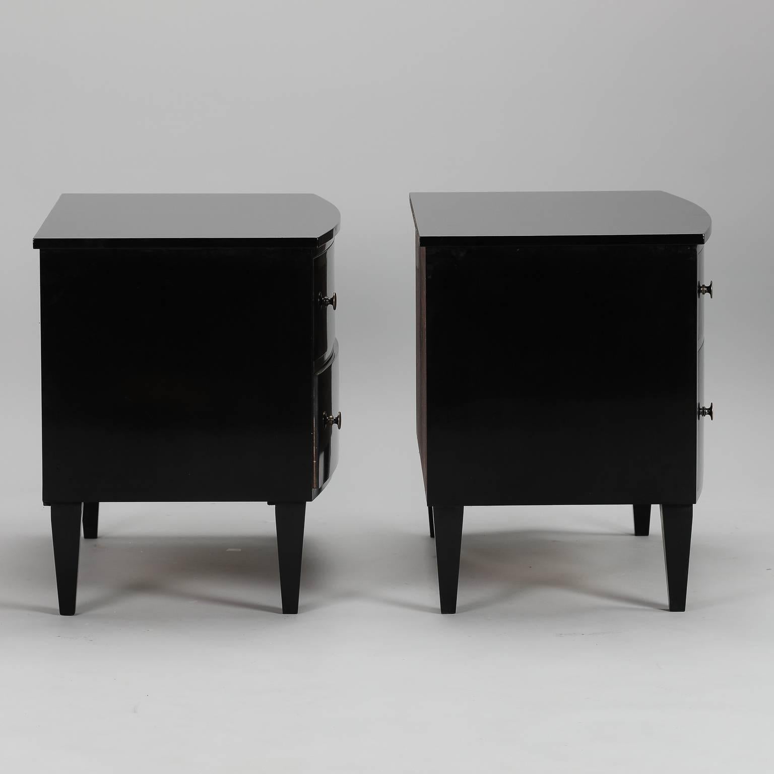Pair of two-drawer chests with new ebonized finish, brass finish and inlaid bone escutcheons. With their versatile size, these chests can flank a sofa or serve as nightstands. Sold and priced as a pair.