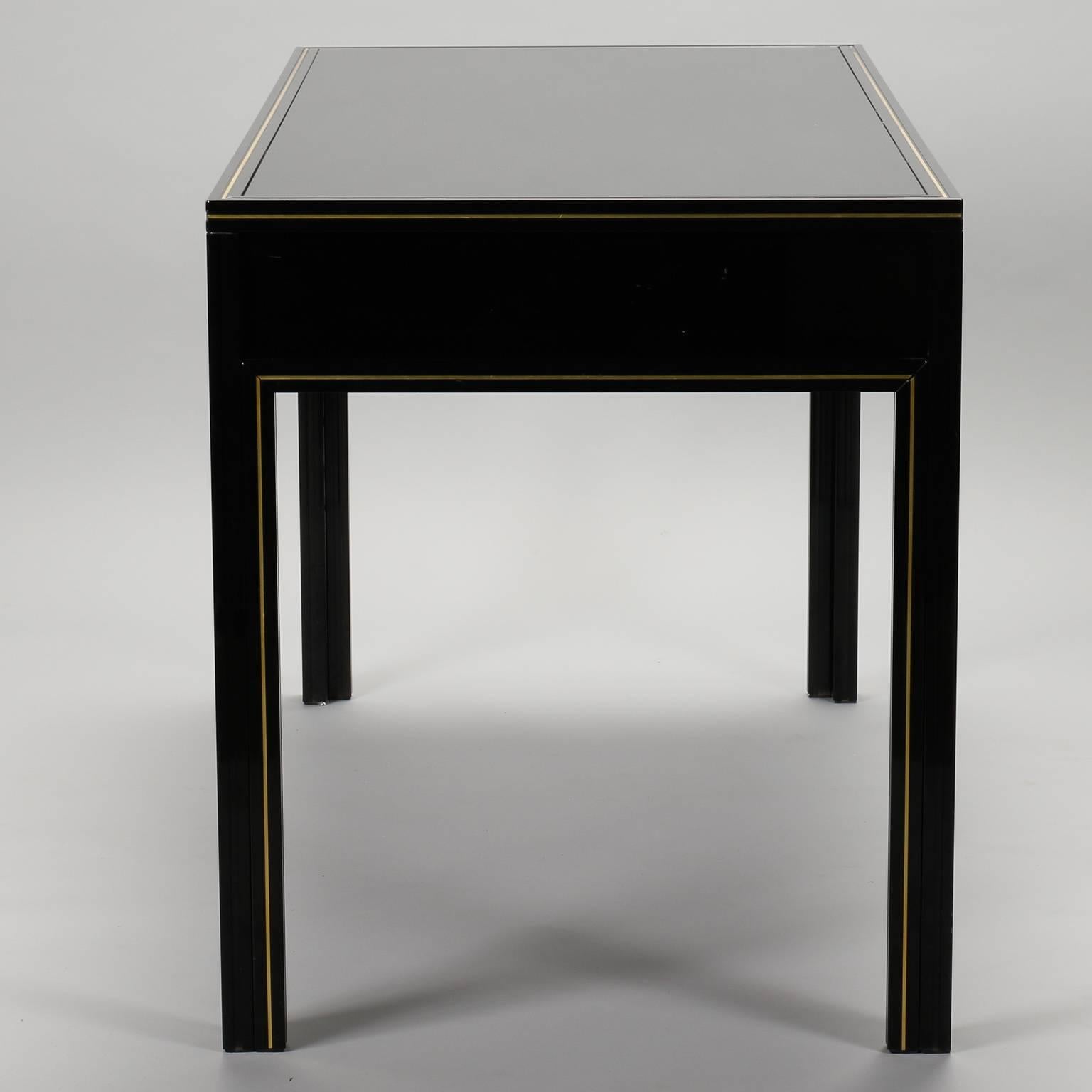Black lacquered wood desk by Paris maker Pierre Vandel. Brass hardware and detail trim, circa 1970s. Other pieces from this collection available at the time of this posting. Please inquire if interested.