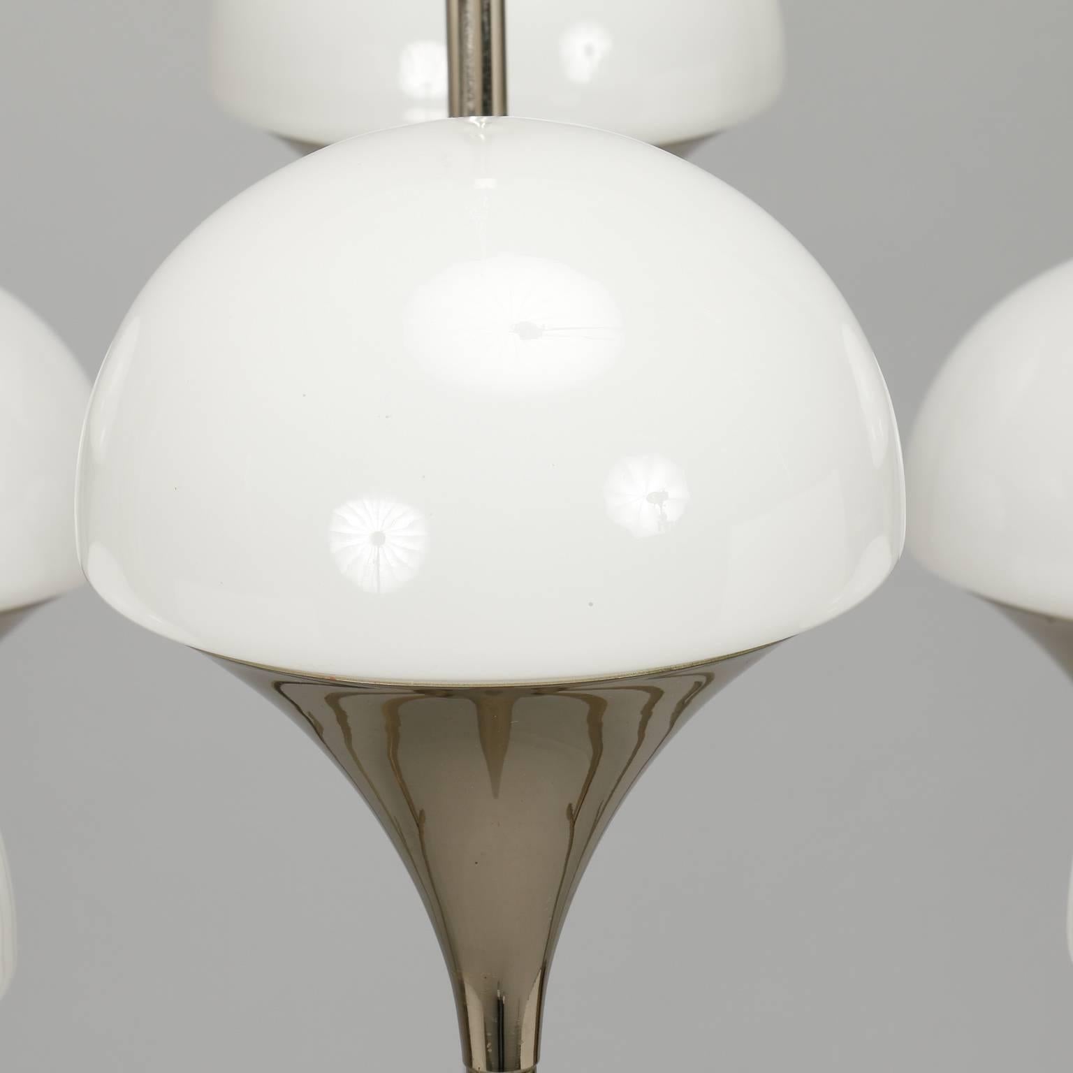 Italian chandelier with a slender chrome frame and eight torchiere style lights topped with white glass domes, circa 1970s. New wiring for US electrical standards. Unknown maker.