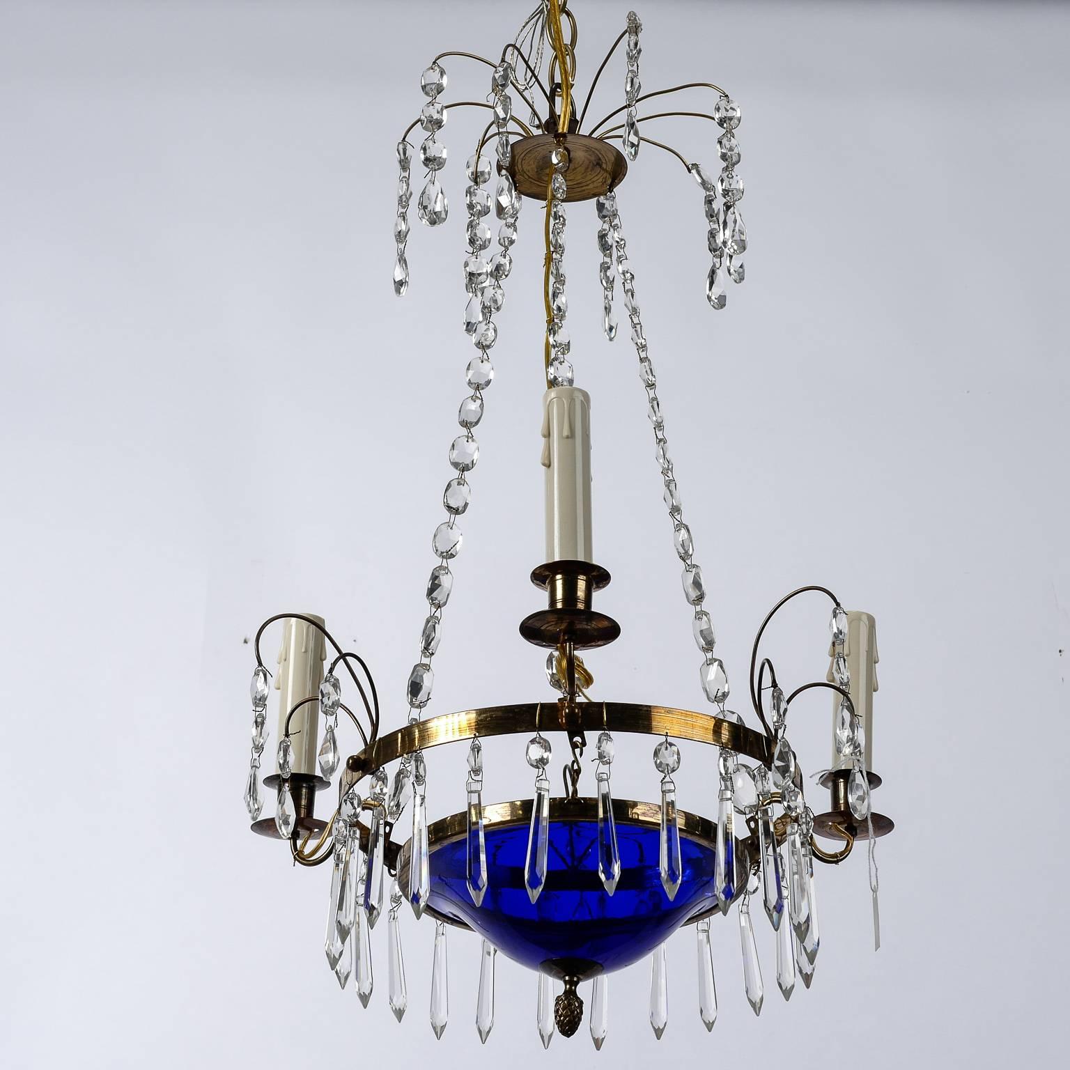 Small Swedish chandelier with brass frame, cobalt blue glass bowl, three candle style lights, crystal beading and pendants, circa 1900. New wiring for US electrical standards.