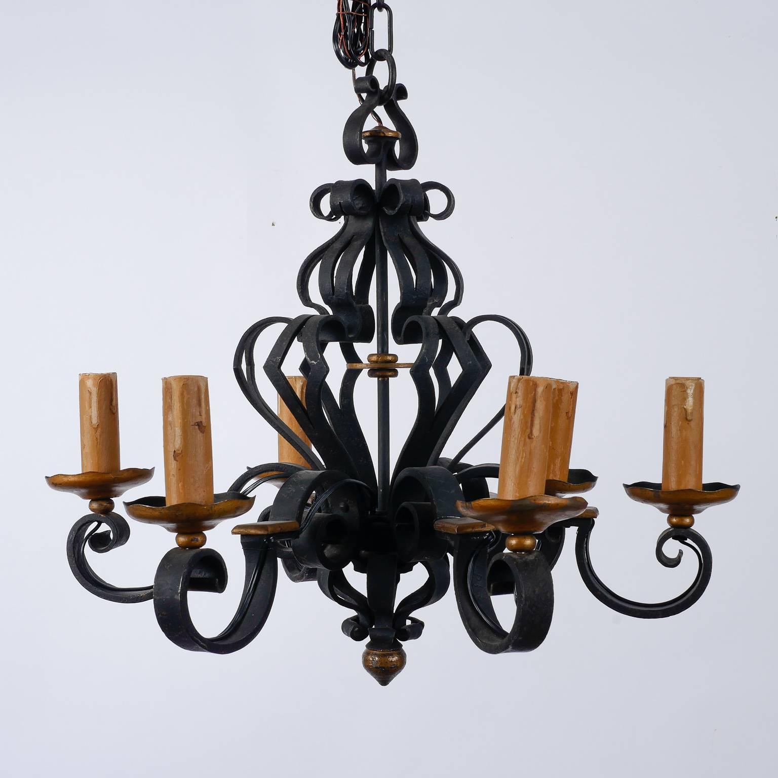 Found in France, this circa 1960s black iron chandelier has six curvy arms and an open work center support. All wiring has been updated for US standards. 