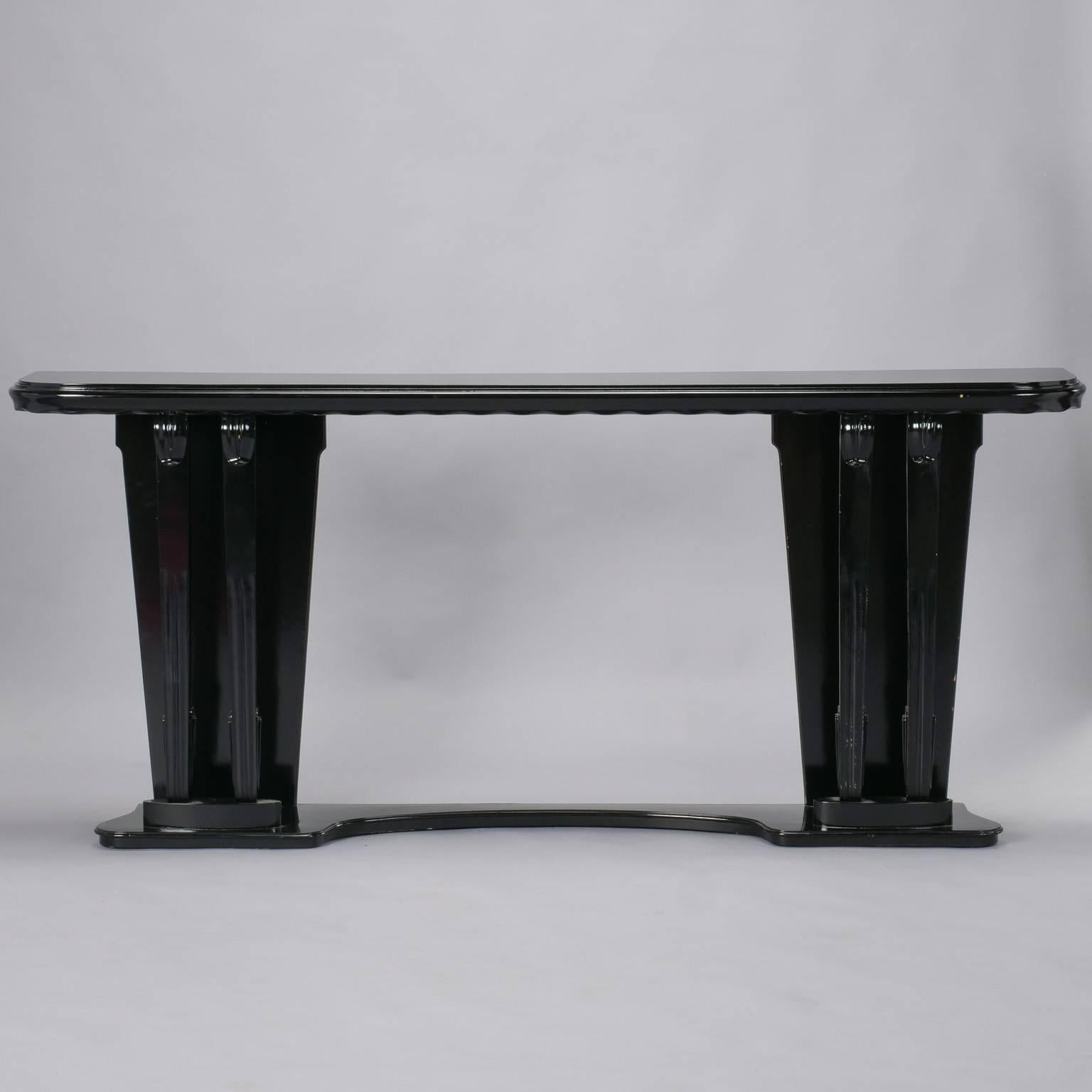 Italian wooden console with ebonized finish, scalloped edge apron and curved pedestal base, circa 1930s. Unknown maker.