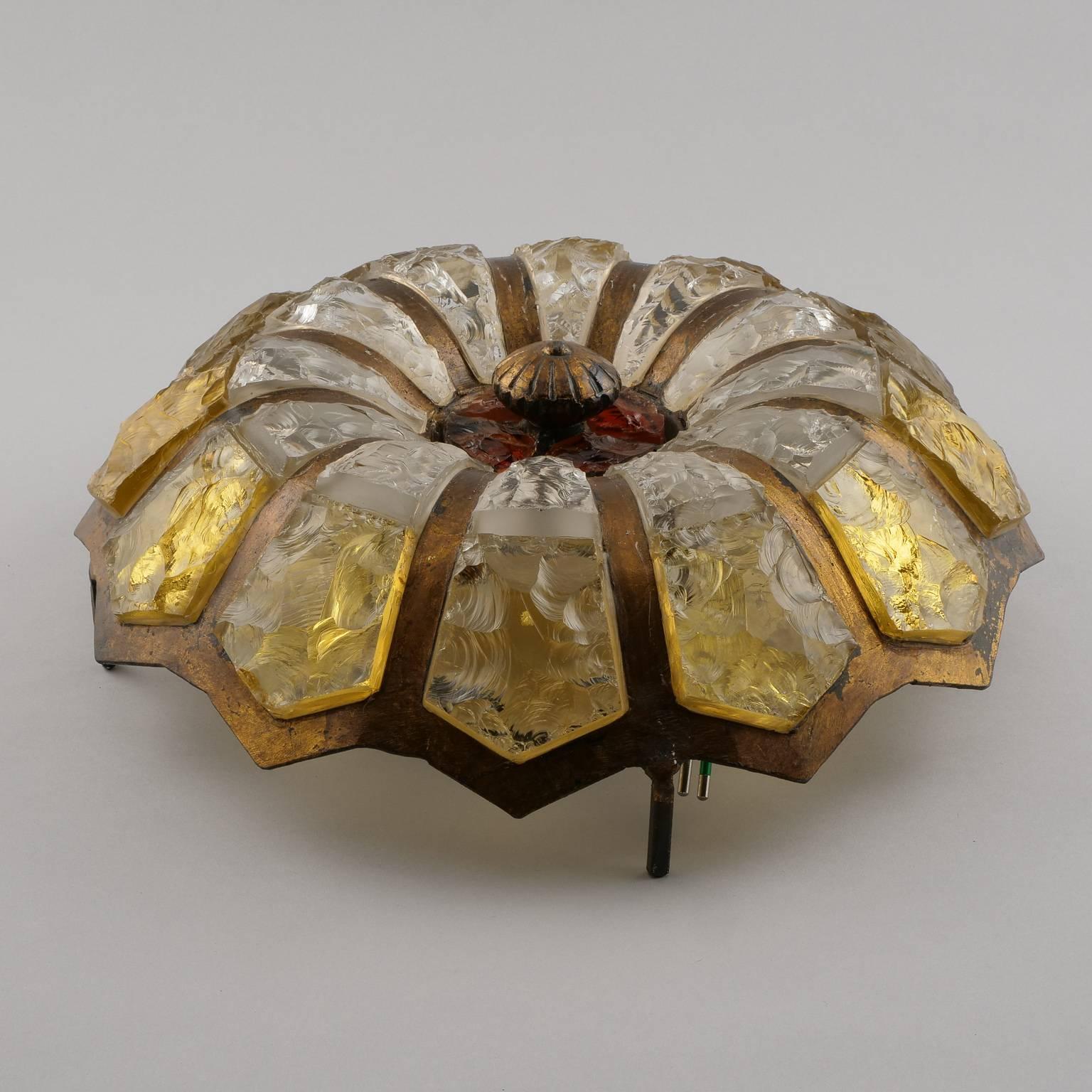 Round flush mount fixture found in Italy features a bronze ribbed frame with petal shaped glass inserts, circa 1950s. Glass is thick with mottled texture in concentric circles of pale gold, clear with a dark amber center. Six sockets. New wiring for