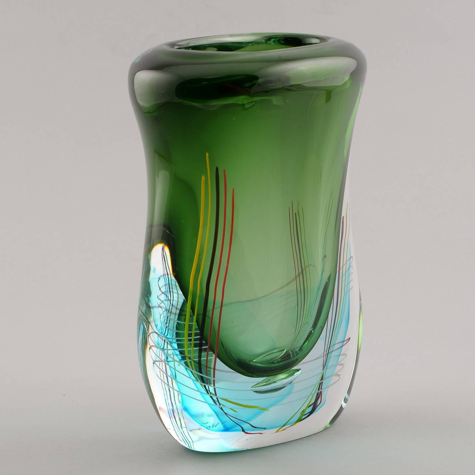 Contemporary Murano art glass vase by Fratelli Toso features a spring green vessel with thick clear glass cased base accented with blue and multicolor streaks.