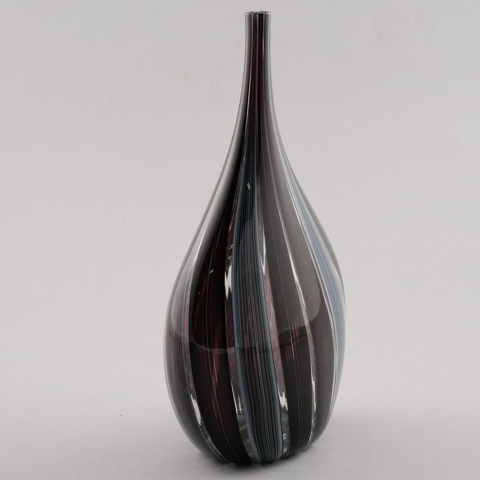 Murano art glass vase signed by artist Adriano dalla Valentina, circa 1980s. Vase is just under 12” tall with deep aubergine and slate blue colored vertical bands terminating in a very narrow neck. Excellent vintage condition.