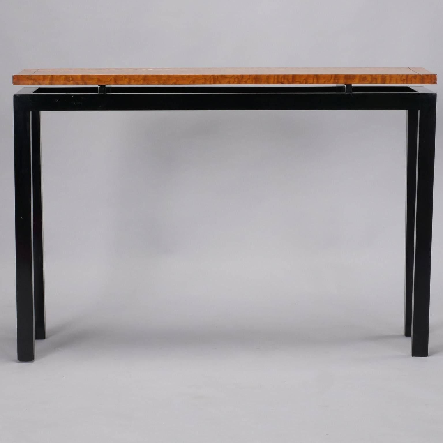 French console table has floating style burr walnut tabletop with Parsons style ebonized base, circa 1970s. Unknown maker. Excellent vintage condition.

        