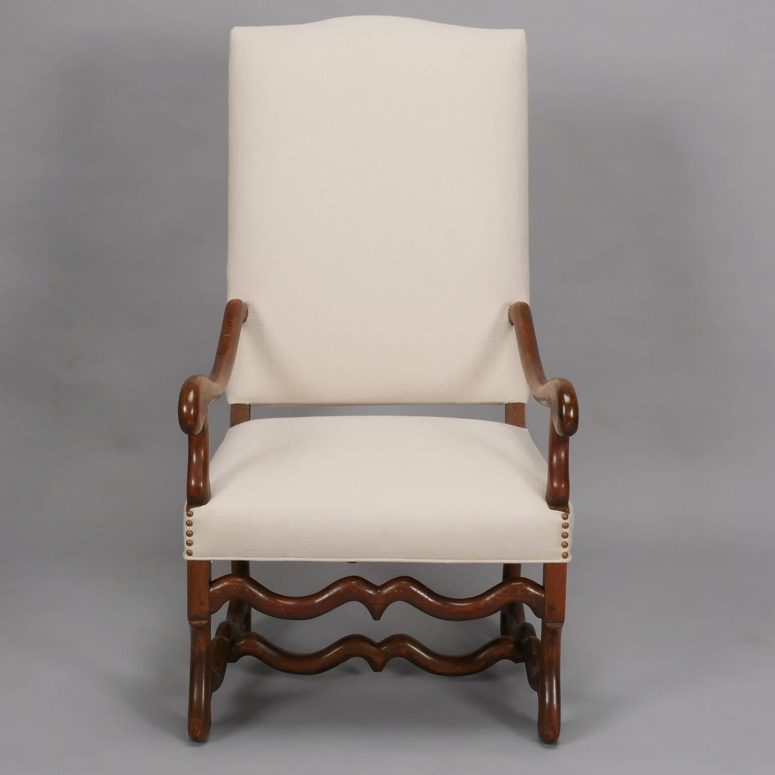 Pair of circa 1920s tall Os de Mouton arm chairs. Dark wood frames, and chairs have been newly upholstered in an off-white cotton/linen blend basket weave fabric. Sold and priced as a pair.

Measure: Arm height 25”
Seat height 19”
Seat depth