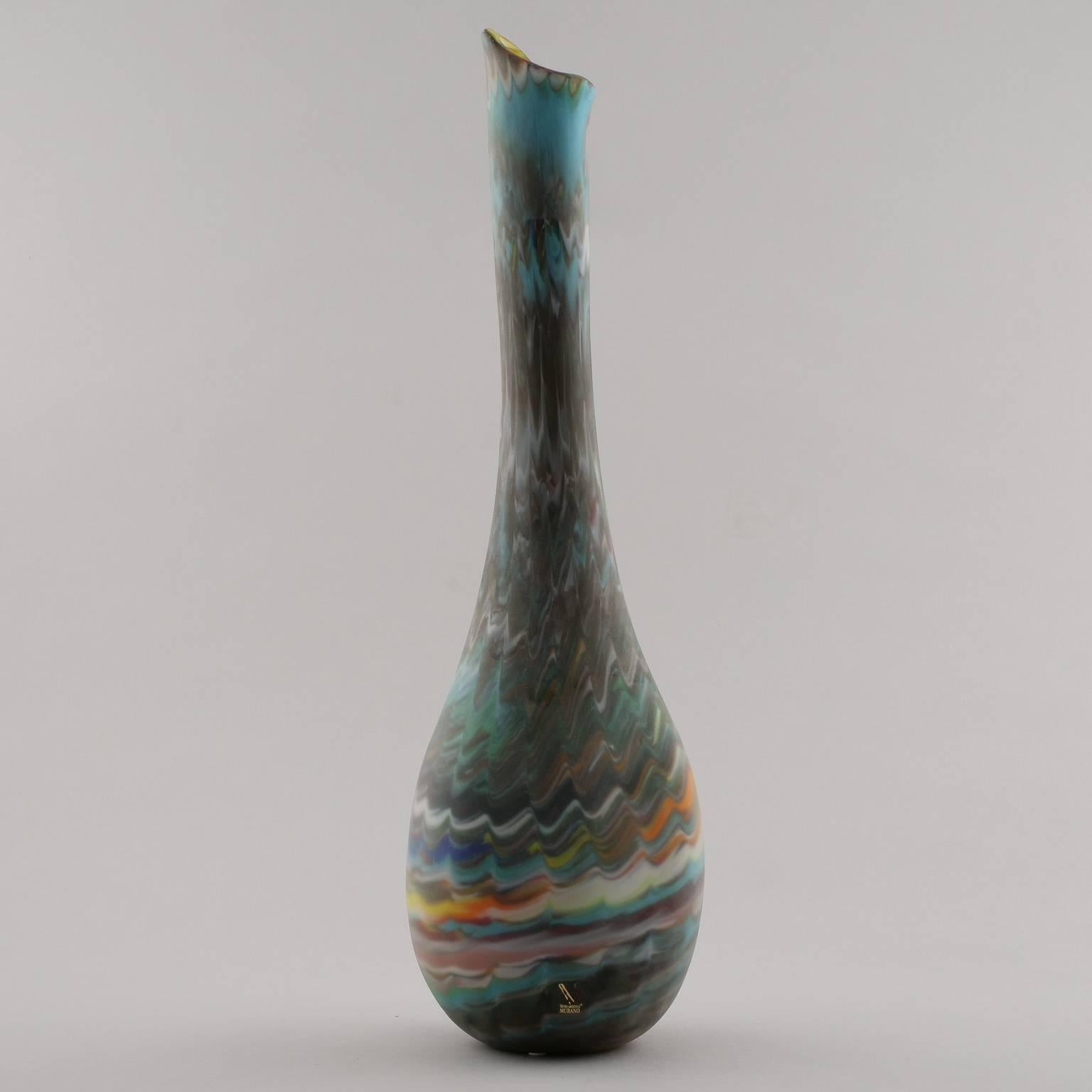 Murano glass vase designed by Missoni with iconic multicolor chevron stripes, circa 2000-2009. Round, flattish base with long, narrow neck. Signed by the artist on underside.
      