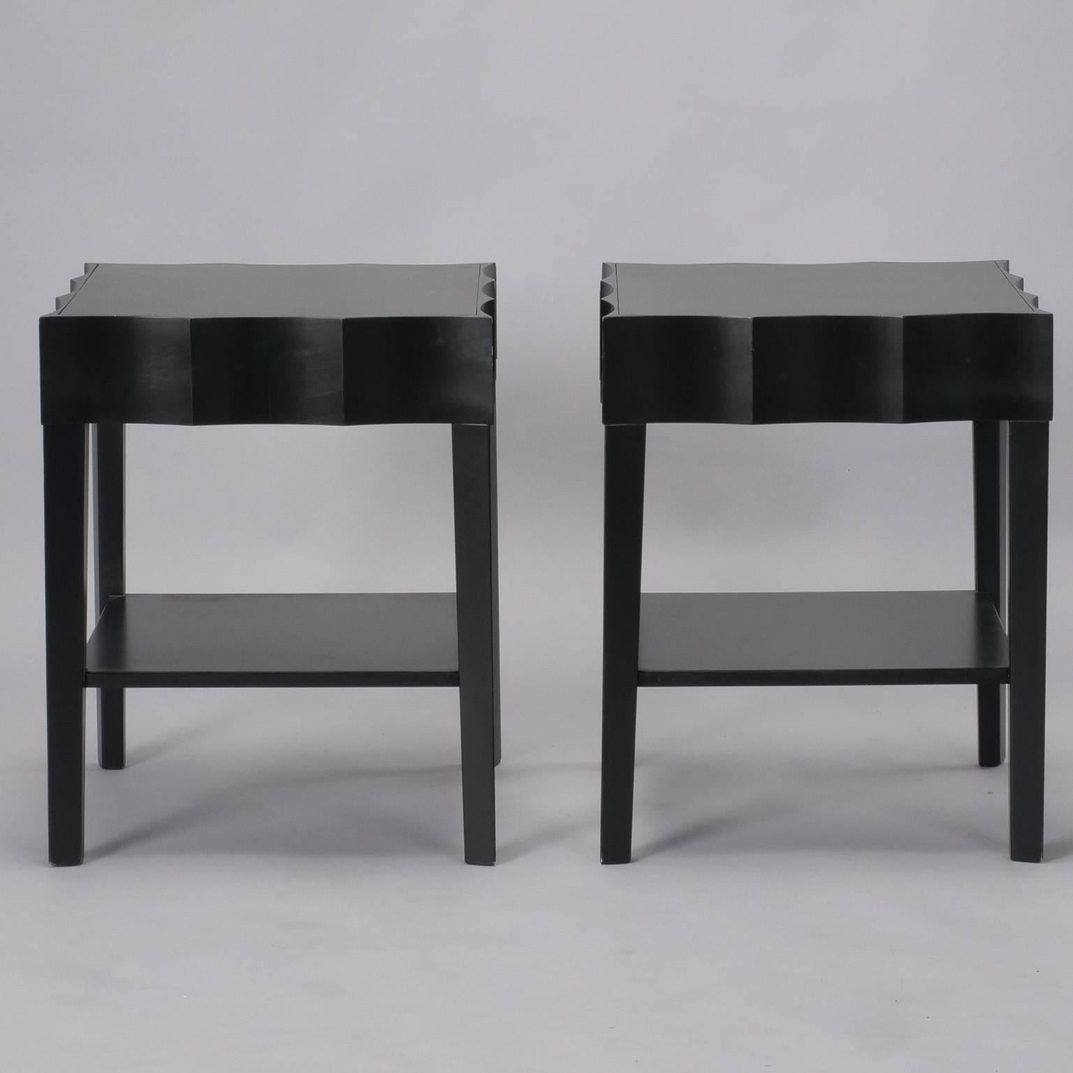 Pair of side tables have ebonized finish and scalloped front, side, and back apron panels, circa 1970s. Unknown maker, found in Italy. Sold and priced as a pair.