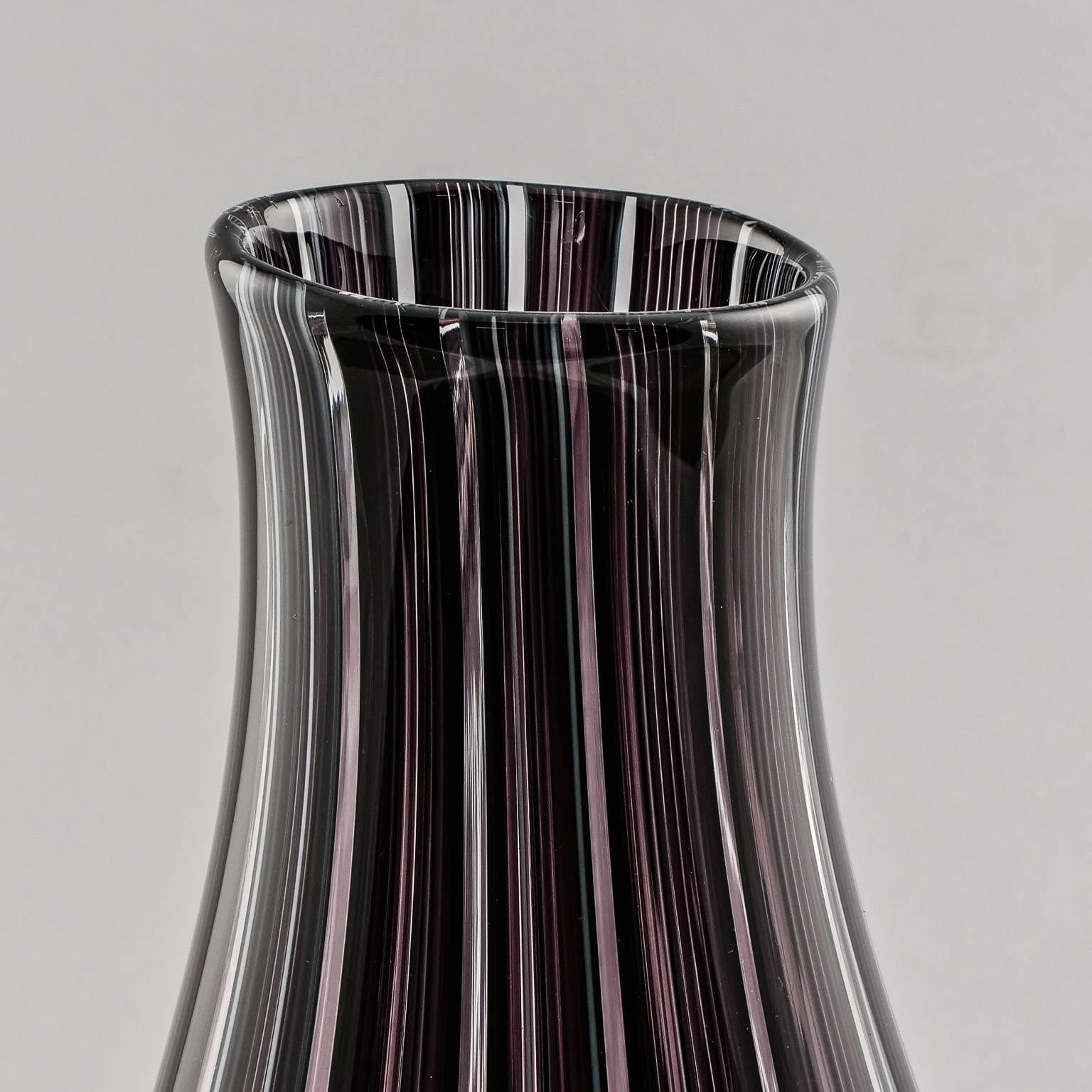 Murano art glass vase signed by artist Adriano dalla Valentina, circa 1980s. Vase is just under 15” tall with deep aubergine vertical bands. Excellent vintage condition.