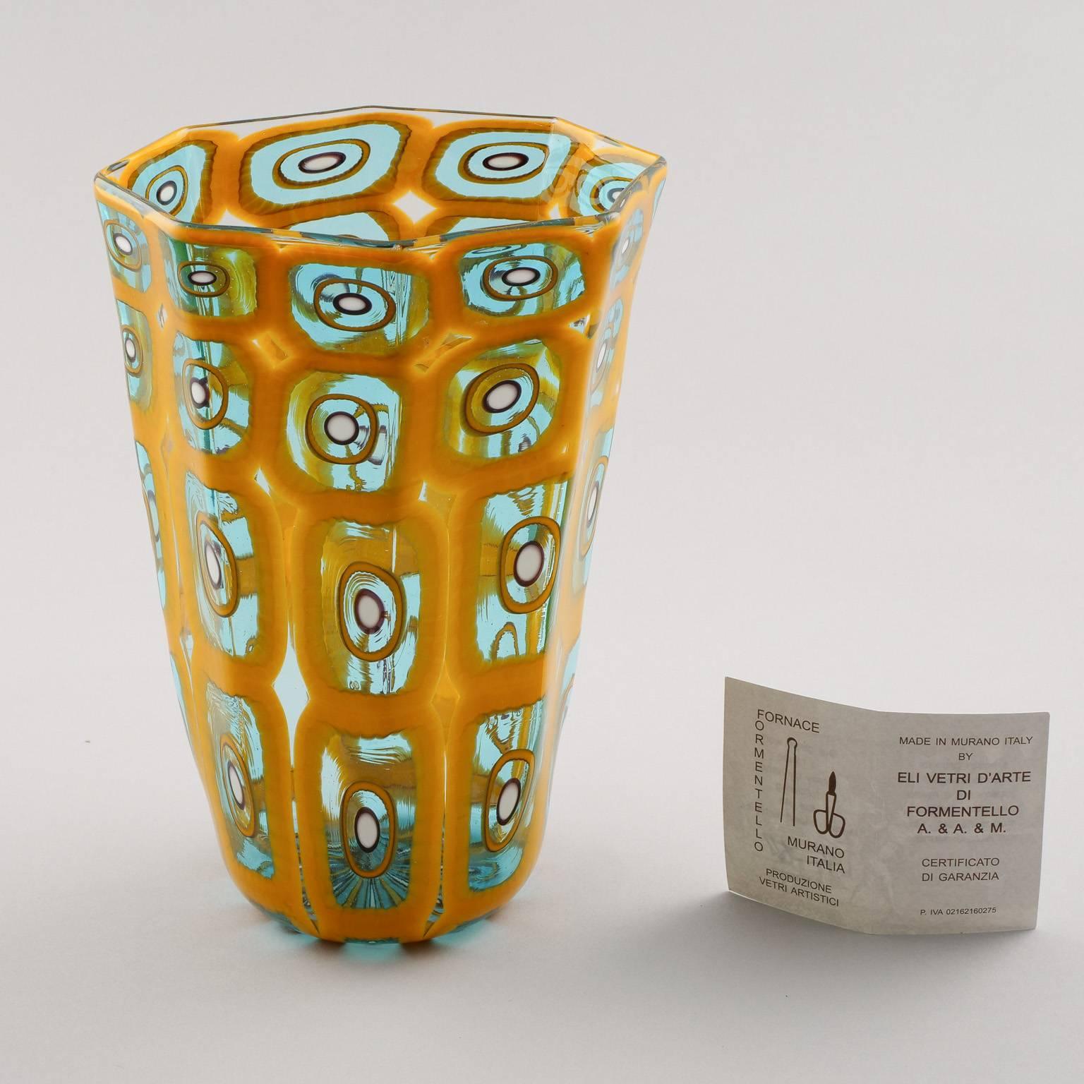 New Murano glass vase by Formentello, circa 2015. Gold colored body is accented with four rows of abstract teal designs. Maker’s card included.