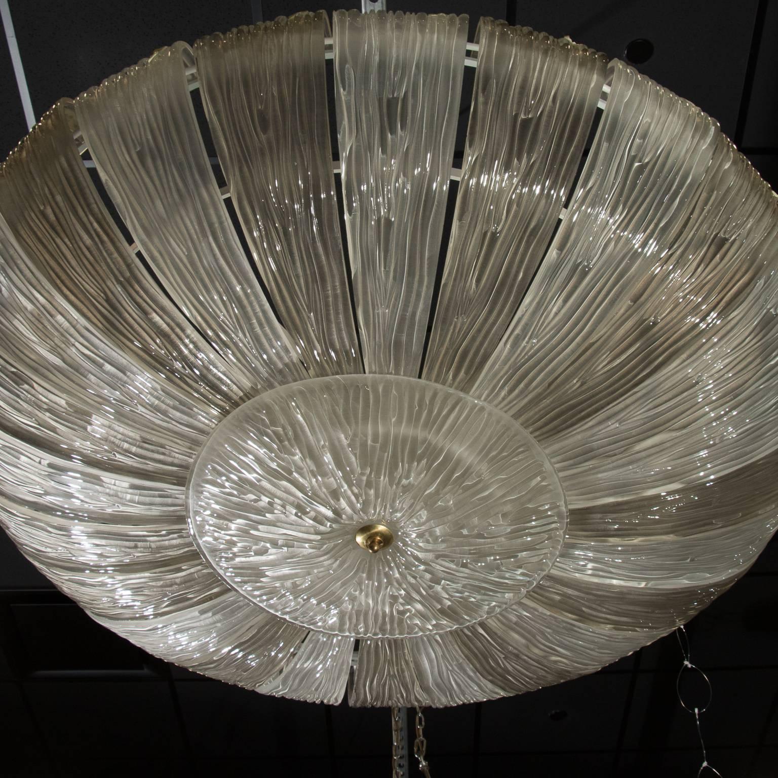 Semi flush mount handblown glass fixture attributed to Barovier & Toso has a center glass bowl surrounded by alternating clear and pale taupe textured, curled petal-form pieces of textured glass. Brass hardware. New wiring for US electrical