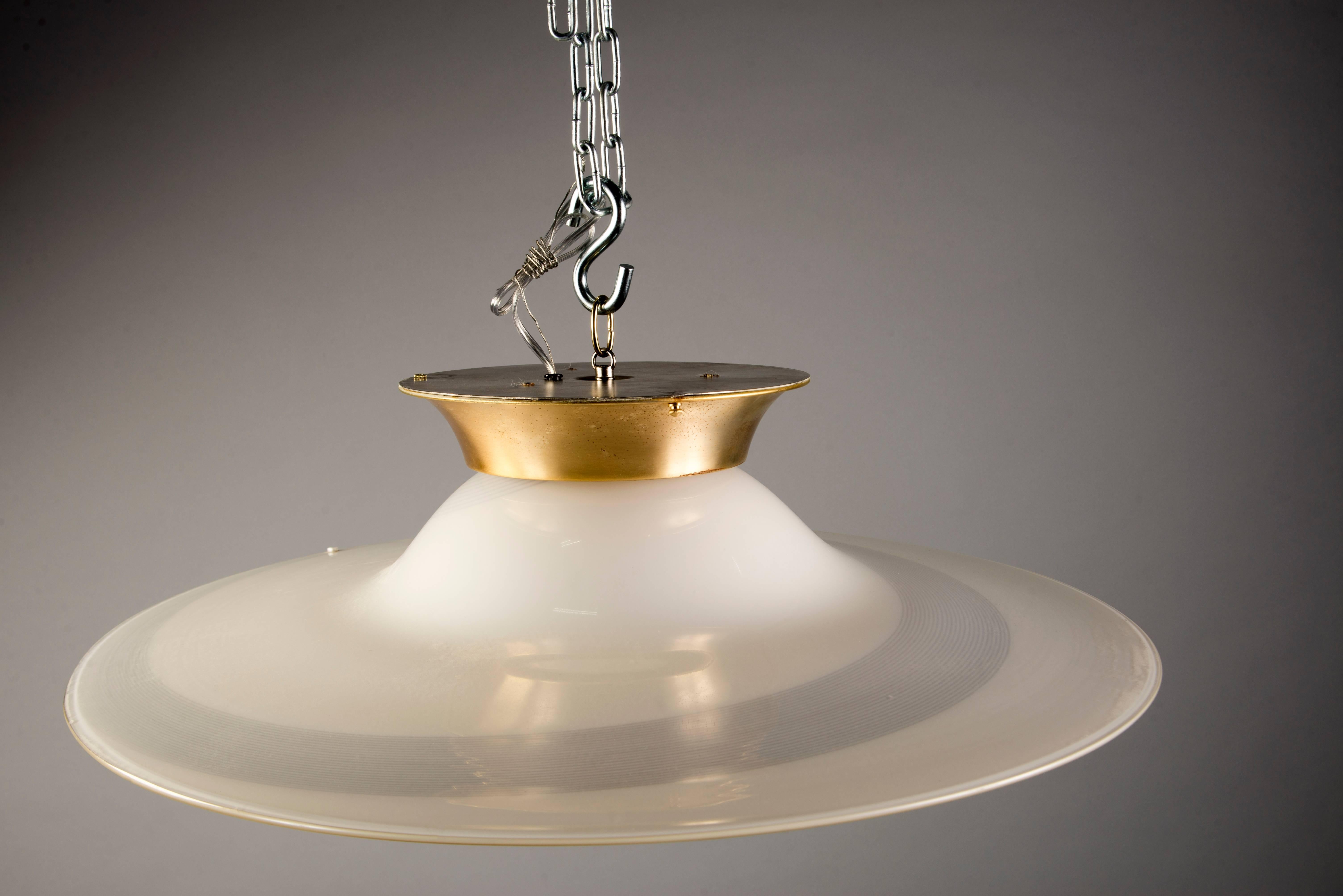 Circa 1970s Murano glass ceiling fixture by Mazzega. Cream colored glass with thin striped black swirl and brass ceiling canopy. Maker’s mark - see detail photo. New wiring for US electrical standards. Shown here with silver crown bulb.
