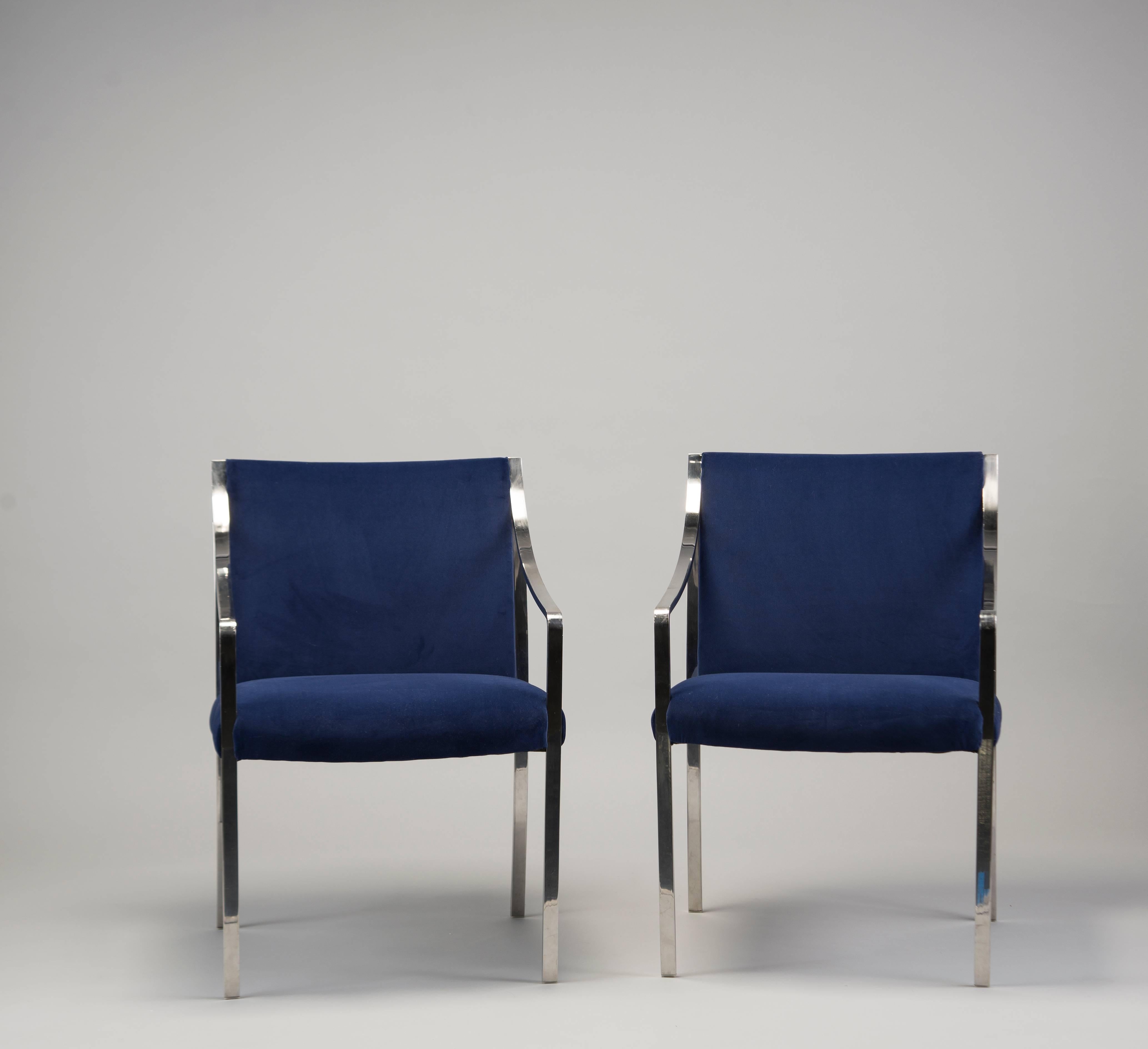 Circa 1970s pair of polished steel frame arm chairs designed by Bert England for Stow Davis. Newly upholstered in royal blue velvet. Seats are 18.5” high and 19” deep. Sold and priced as a pair. Two pairs available at time of posting. 
