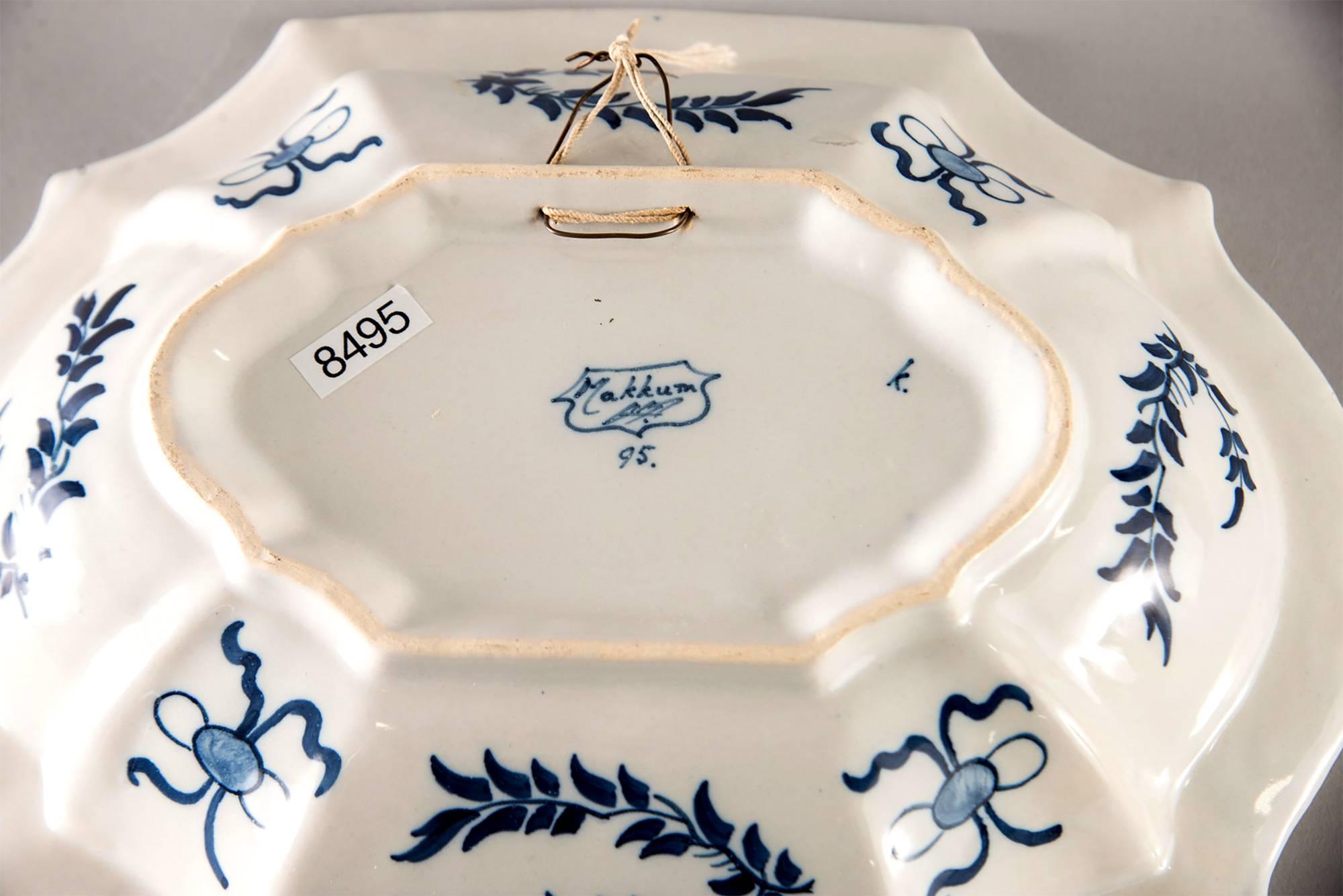 Delft platter marked on the underside of base with a blue on white design of two Chinese figures with pea hens and flowers, circa 1920s. Excellent vintage condition with no flaws found.