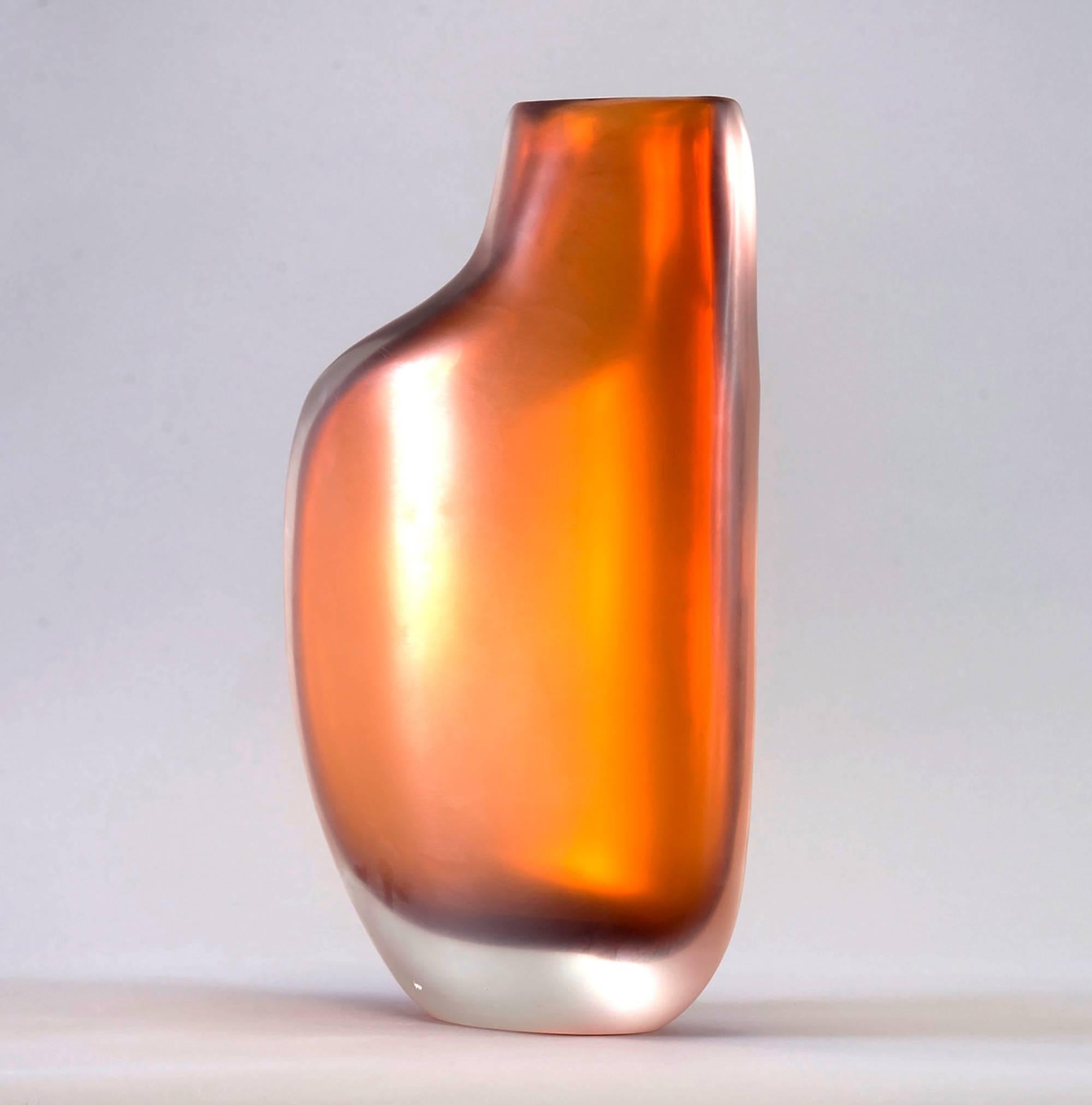 Limited edition handcrafted vase in rich amber colored cased glass, circa 2017. Designed by Ivan Baj at Arcade, this piece has a sensual biomorphic shape and is signed by the artist and numbered 24 of 33. New condition with no flaws found.