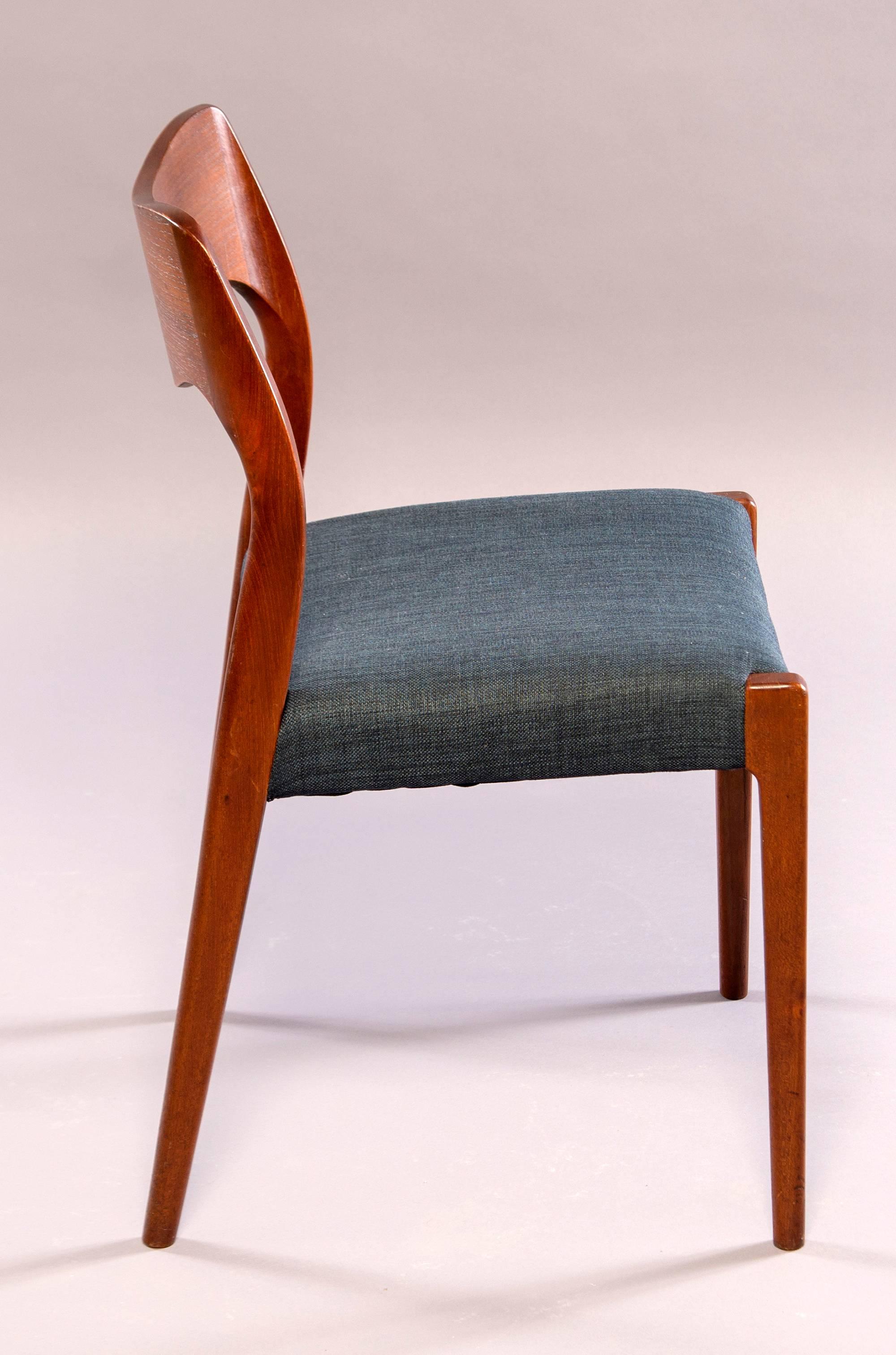 Set of four Danish midcentury teak dining chairs, circa 1960s. Unknown maker. Newly upholstered in medium blue fabric. Measure: Seats are 17.25” high and 16” deep. Sold and priced as a set.