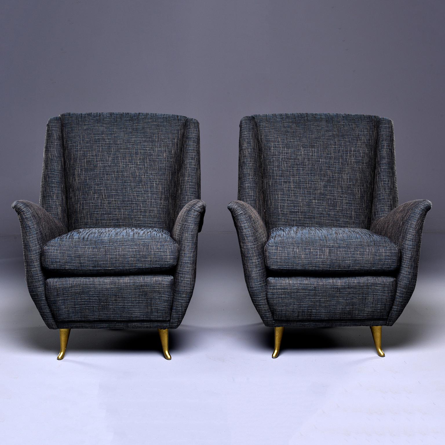 Pair of circa 1960s, Italian armchairs are newly upholstered in a blue and taupe tweed. Curvy lines with flared arms and side wings, high backrests and gold metal legs/feet. Found in Italy. Unknown maker, but in the style and period of Paolo Buffo.