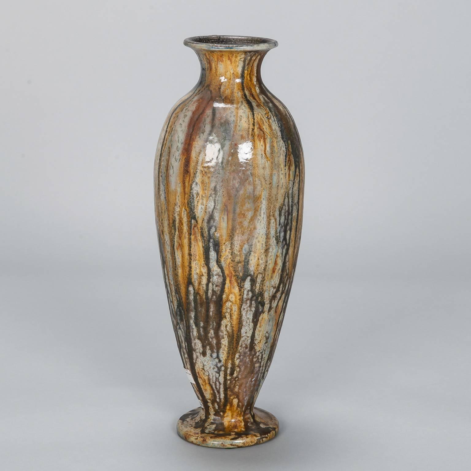 Glazed pottery vase by renowned Belgian ceramic artist Roger Guerin, circa 1930s. Drip wash glaze in tones of ochre and grey. Incised signature on bottom.