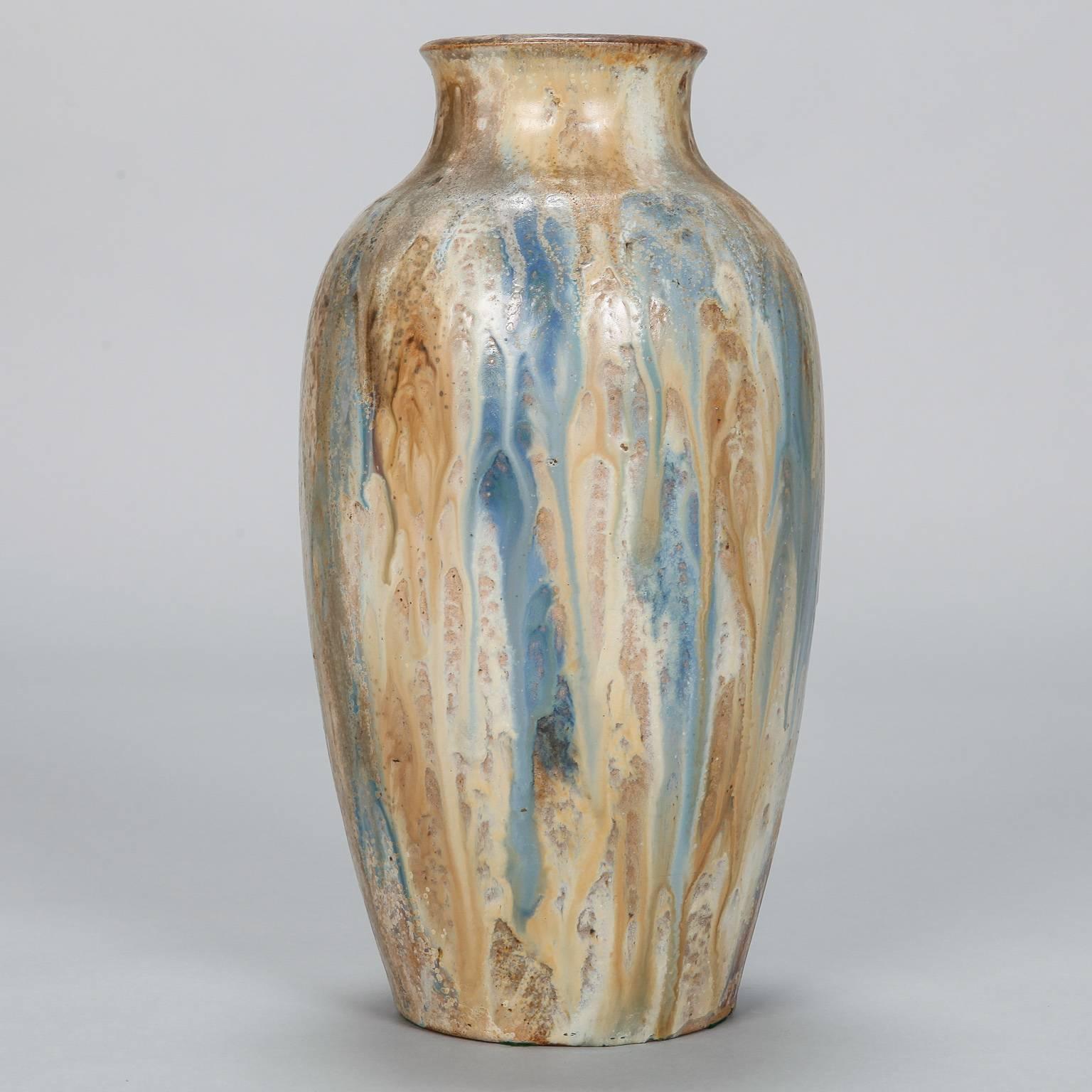 Tall signed vase by Belgian ceramic artist Edgar Aubry in classic form with drip glaze in tones of ochre and blue. Dates from approximately 1930.

 