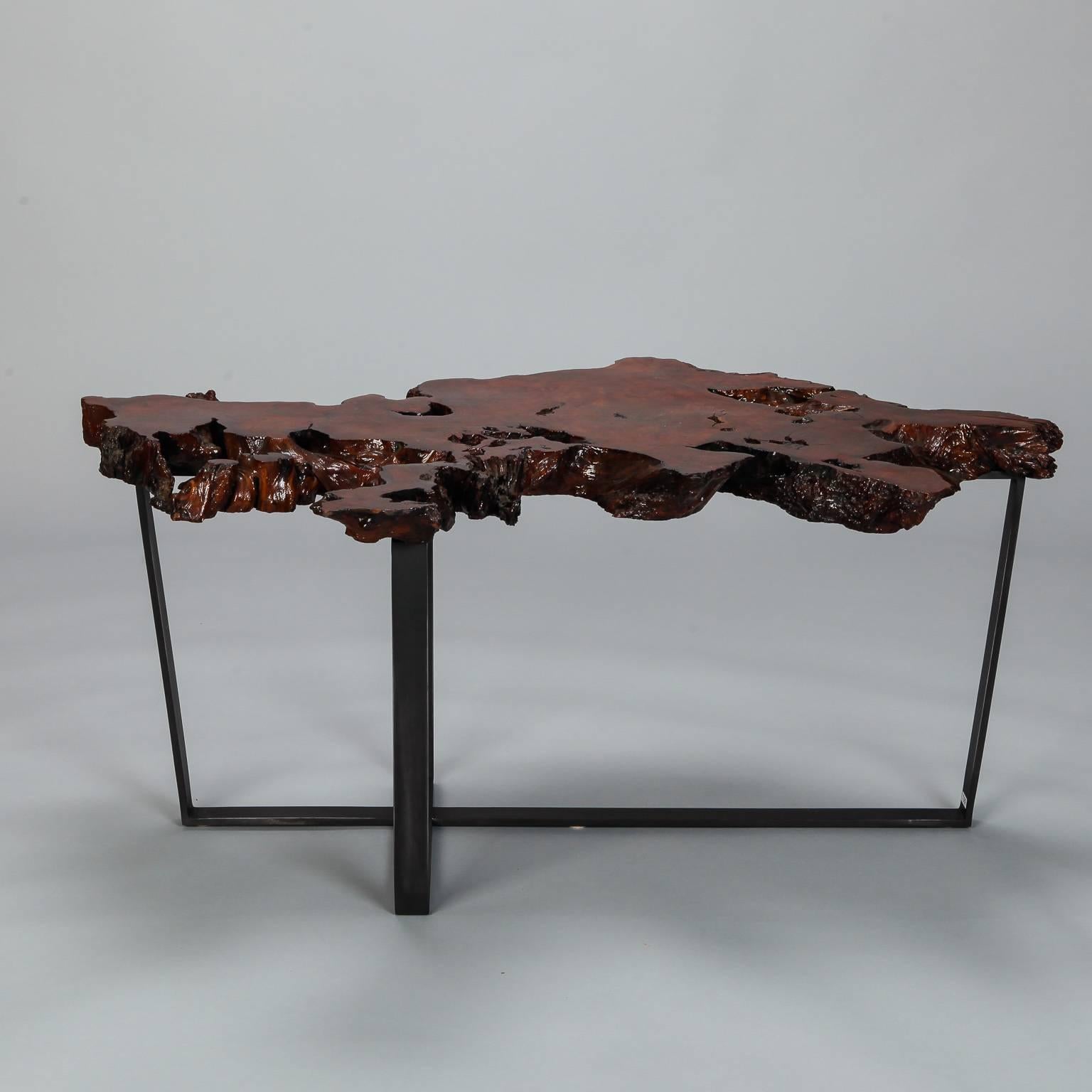 Table was custom-made using a petrified slab of live edge wood and new metal base with black finish.

 