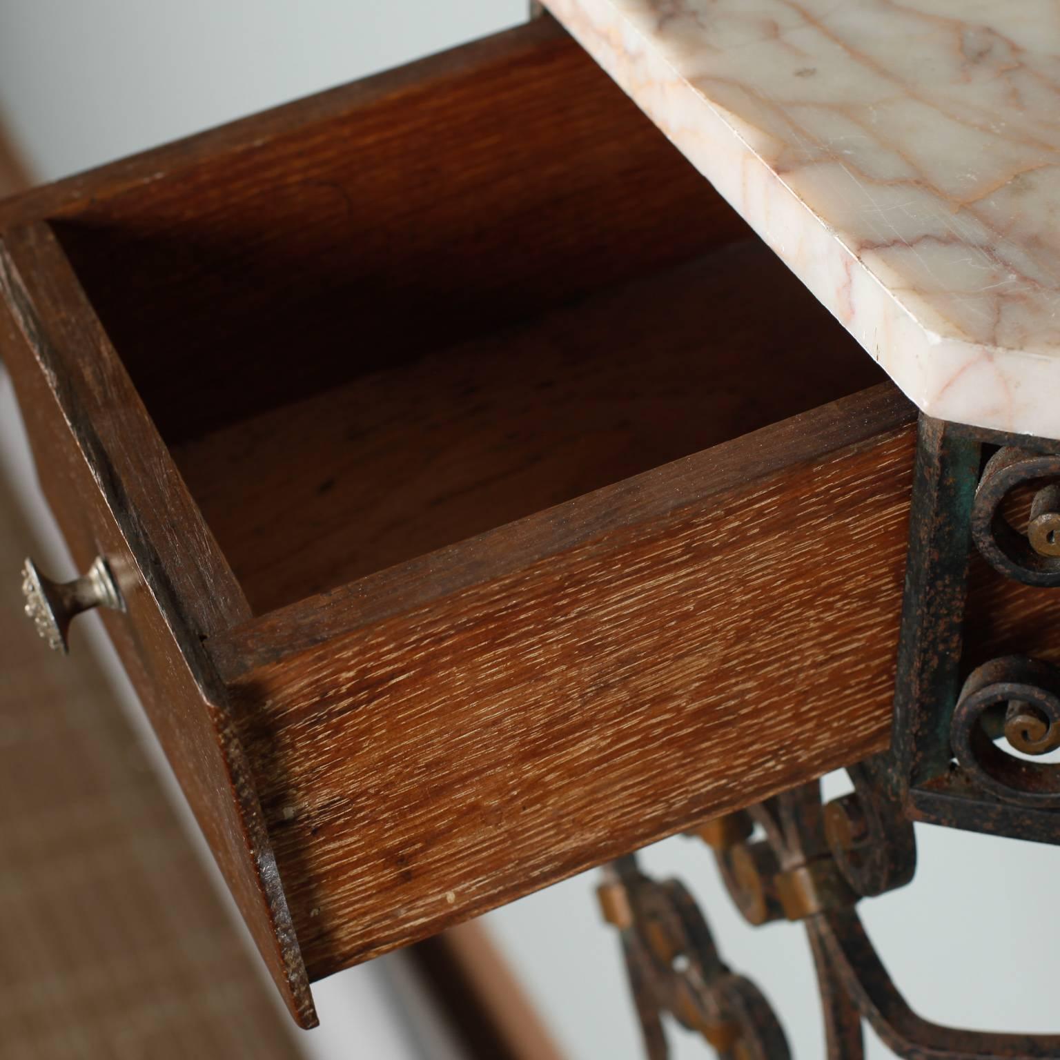 Pair of French wall hung consoles has marble tops and hand worked iron frames with brass accents and small center wooden drawer, circa 1930s. Sold and priced as a pair.

   