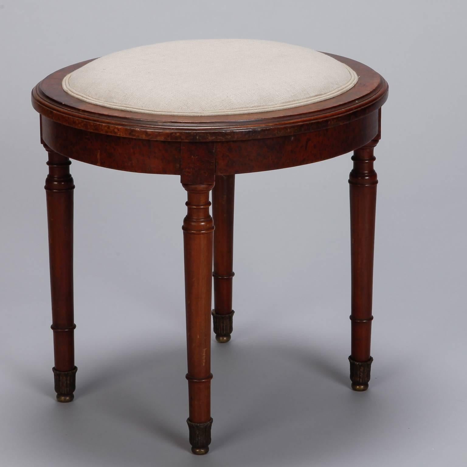 English upholstered stool has a round burr walnut frame and newly upholstered natural color linen seat. Stool seat is 19” high, circa 1920s.
  