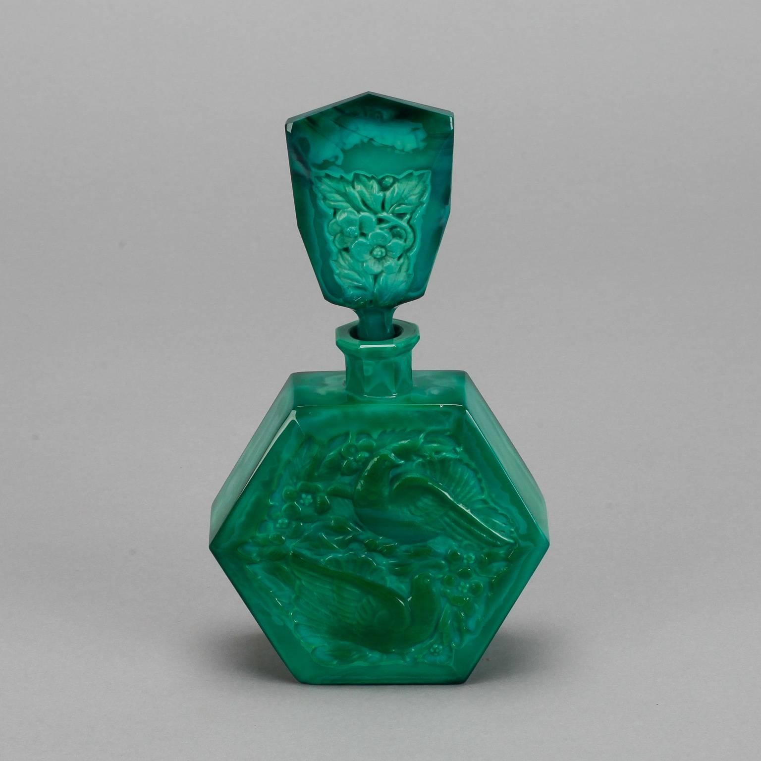 Circa 1930s Czech malachite glass perfume bottle known as the Love Bird model from the Ingrid line manufactured by Curt Schlevogt Co. The bottle features two birds on the bottle body and floral decorations on the stopper. 