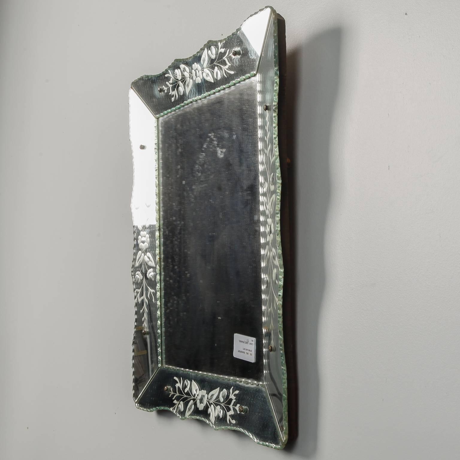 Rectangular venetian mirror with scalloped inner and outer edge, circa 1930s. Etched floral spray on frame. Mirror can be hung vertically or horizontally.  Actual Mirror Size:  14.5” h x 22.75” w