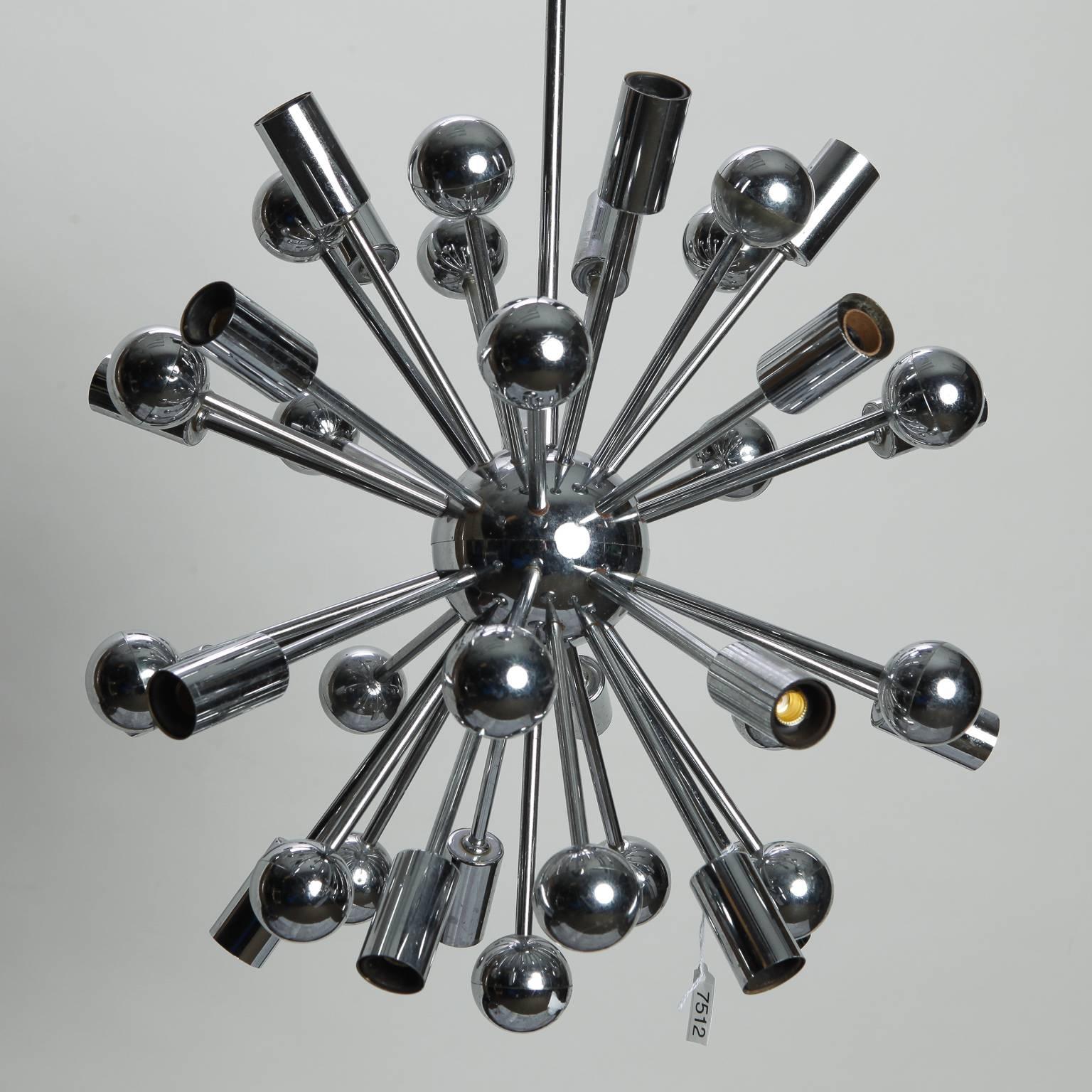 Chrome 20-light Sputnik style chandelier, circa 1970s. Found in Belgium, this orb shaped fixture has a chromed metal base with several arms terminating in 20 candelabra sockets and chromed plastic globes. Chromed ceiling canopy. New wiring for US