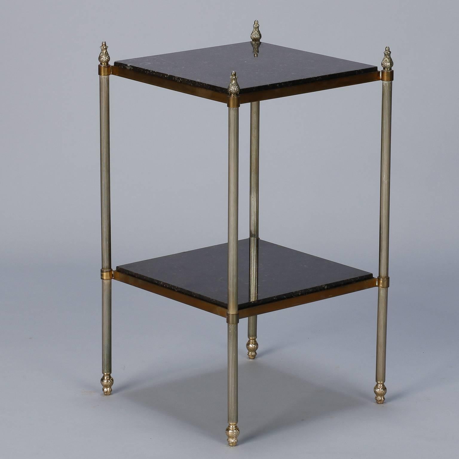 French two-tier marble and brass side table.

Small side table with reeded brass legs and decorative finials with two square black marble tiers.
      