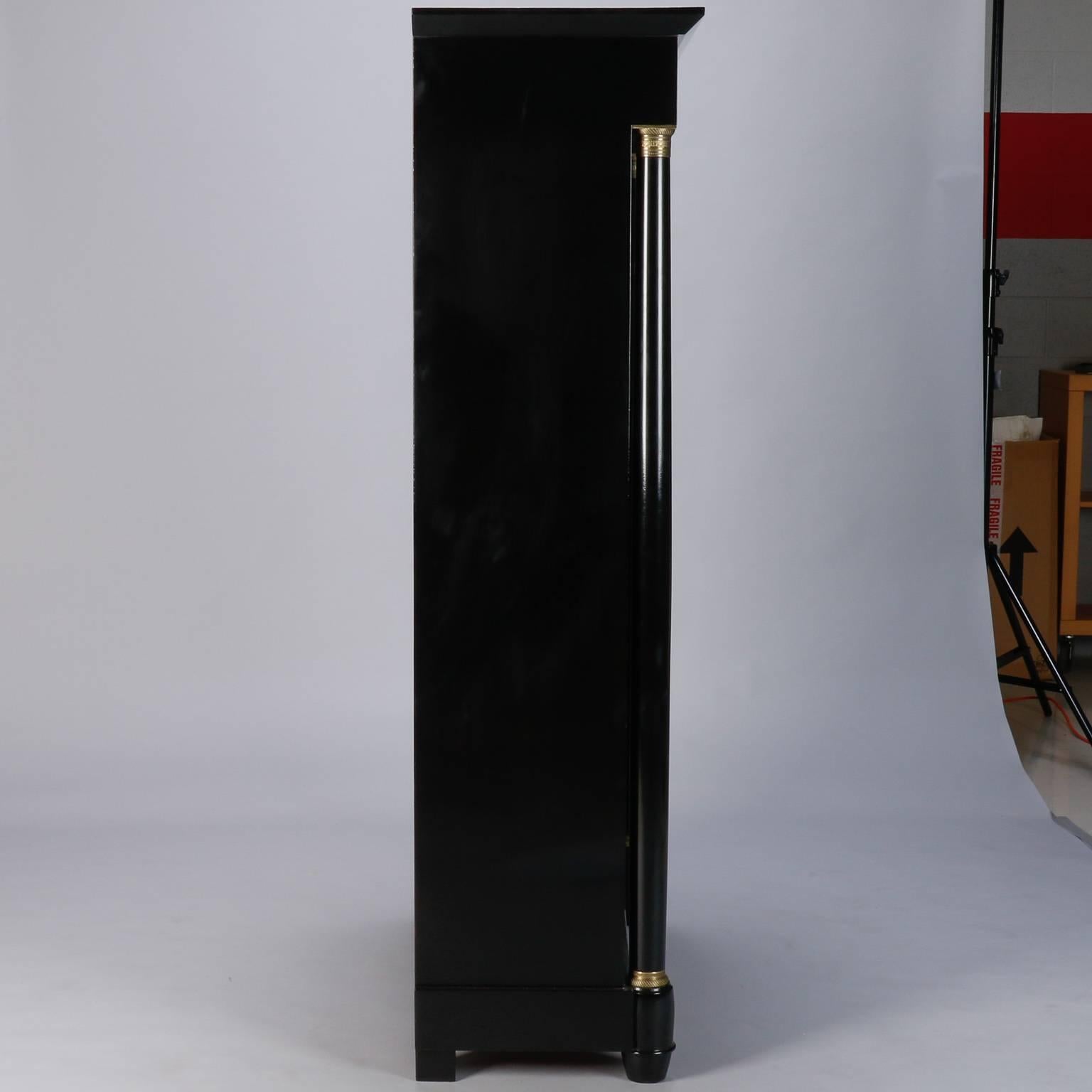 Found in England, this circa 1940s tall open front bookcase is in Classic Empire form with newly ebonized finish and decorative brass mounts. Shelves are 12.5” deep.

.