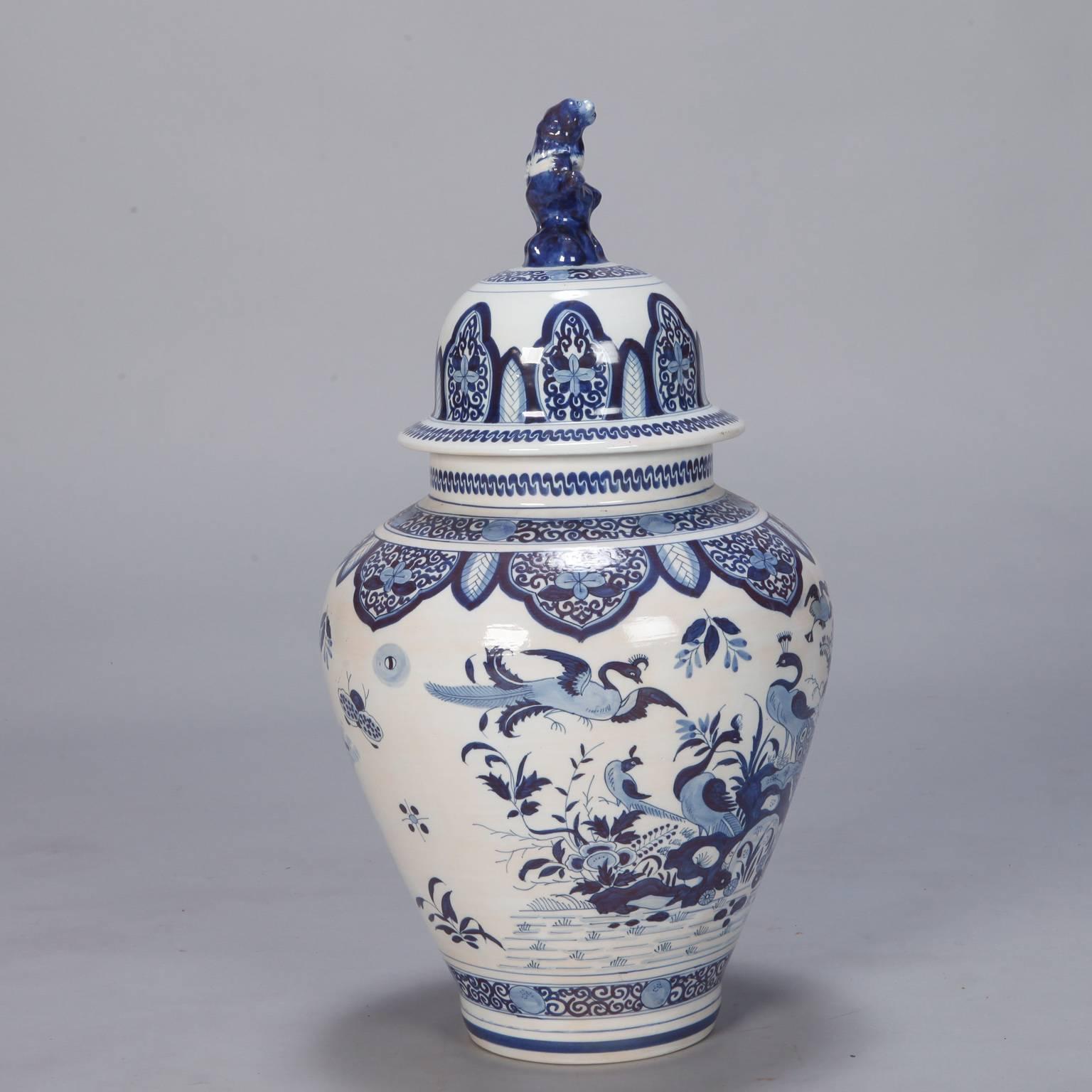Large Dutch covered urn or vase with a Chinese style blue and white decorative glaze and sculpted foo dog handle on the lid, circa 1900.