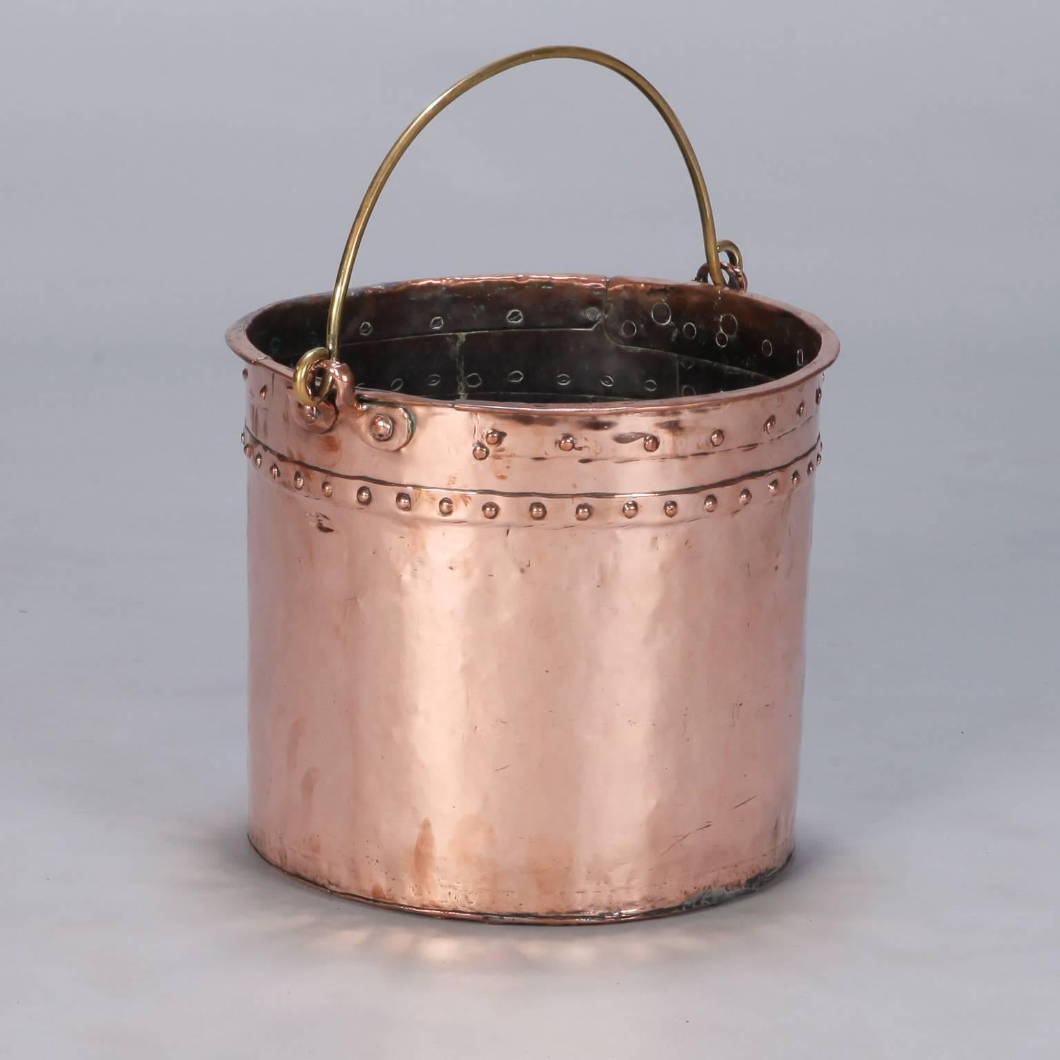 Found in England, this large late 19th century copper pot has a contrasting brass handle.
 