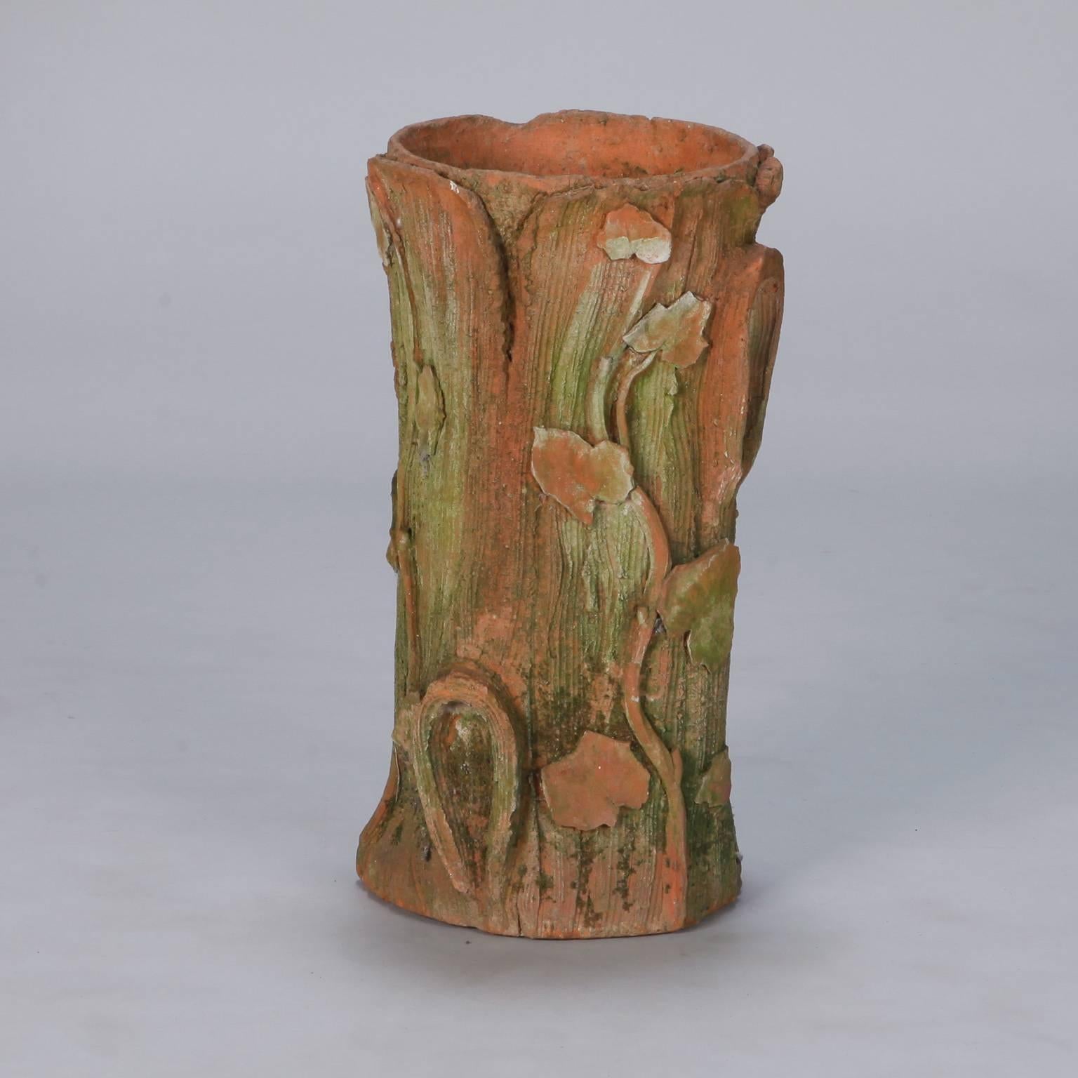 Large terra cotta vessel that can serve as umbrella stand in form of tree log with bark form details and moss-like green glaze, circa 1910. Found in England.