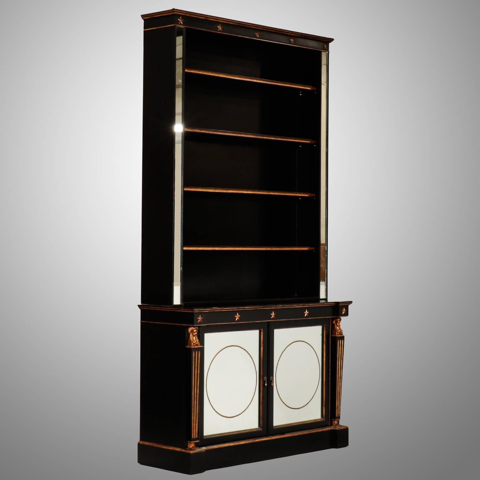 Late 19th century cabinet with bookcase has a freshly ebonised finish with carved and gilded details. Lower cabinet has one internal shelf, mirrored panel fronts with reverse painted detail of rope twist circles, reeded columns with carved and