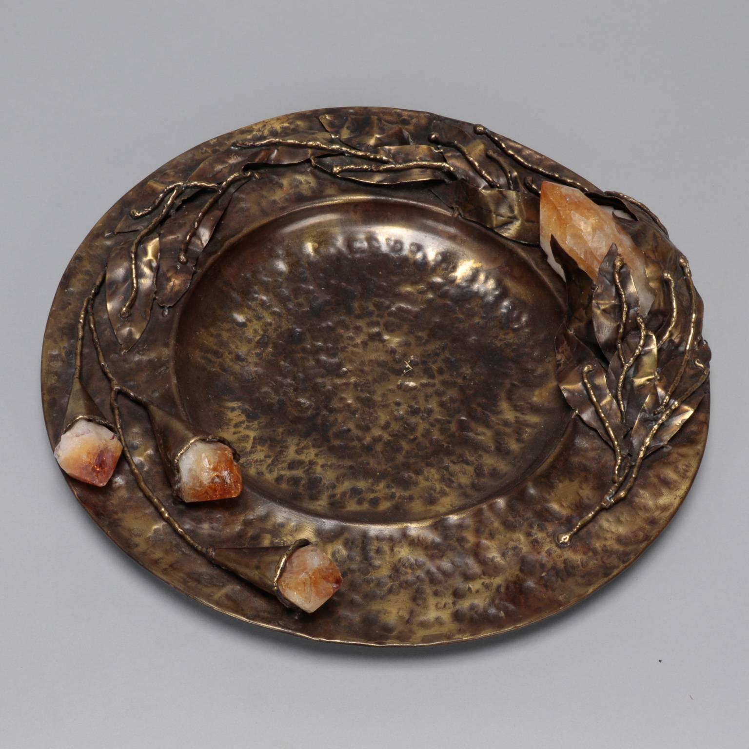 Found in Italy, this Mid-Century decorative plate dates from the 1970s. Plate is 13” diameter and has hammered texture with sculpted leaves and blooms with gold quartz crystal accents. Signed “Lionel” by the artist. We currently have several pieces