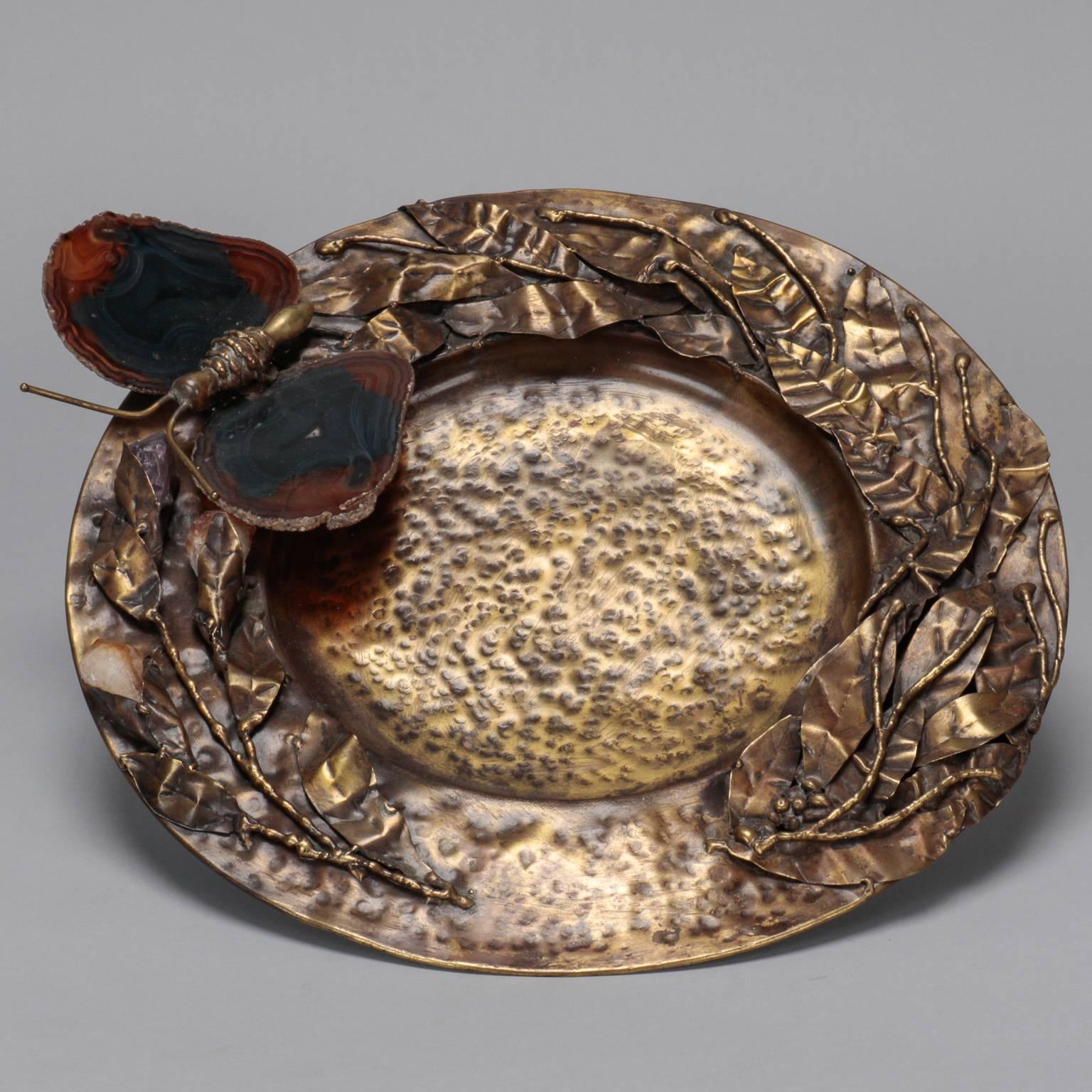 Found in Italy, this Mid-Century decorative plate dates from the 1970s. Plate is 13” diameter and has hammered texture with sculpted leaves and blooms and a large sculpted butterfly on the rim with slices of tortoiseshell colored agate wings and a