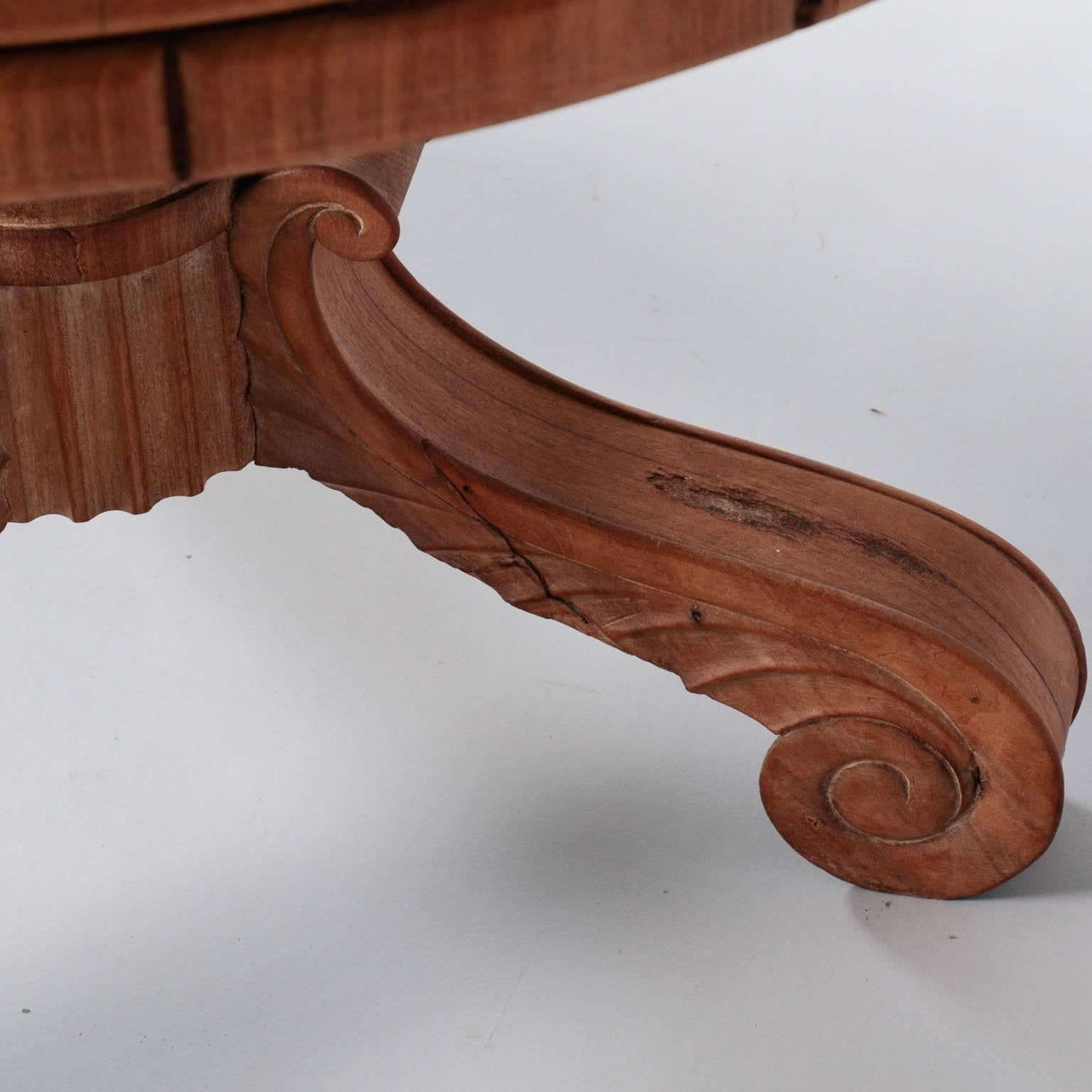 French center table, circa 1920s has a three leg base with carved acanthus leaf detail, a turned center support shaft, carved ridges along the table edge and a round pale gray marble top.
                           