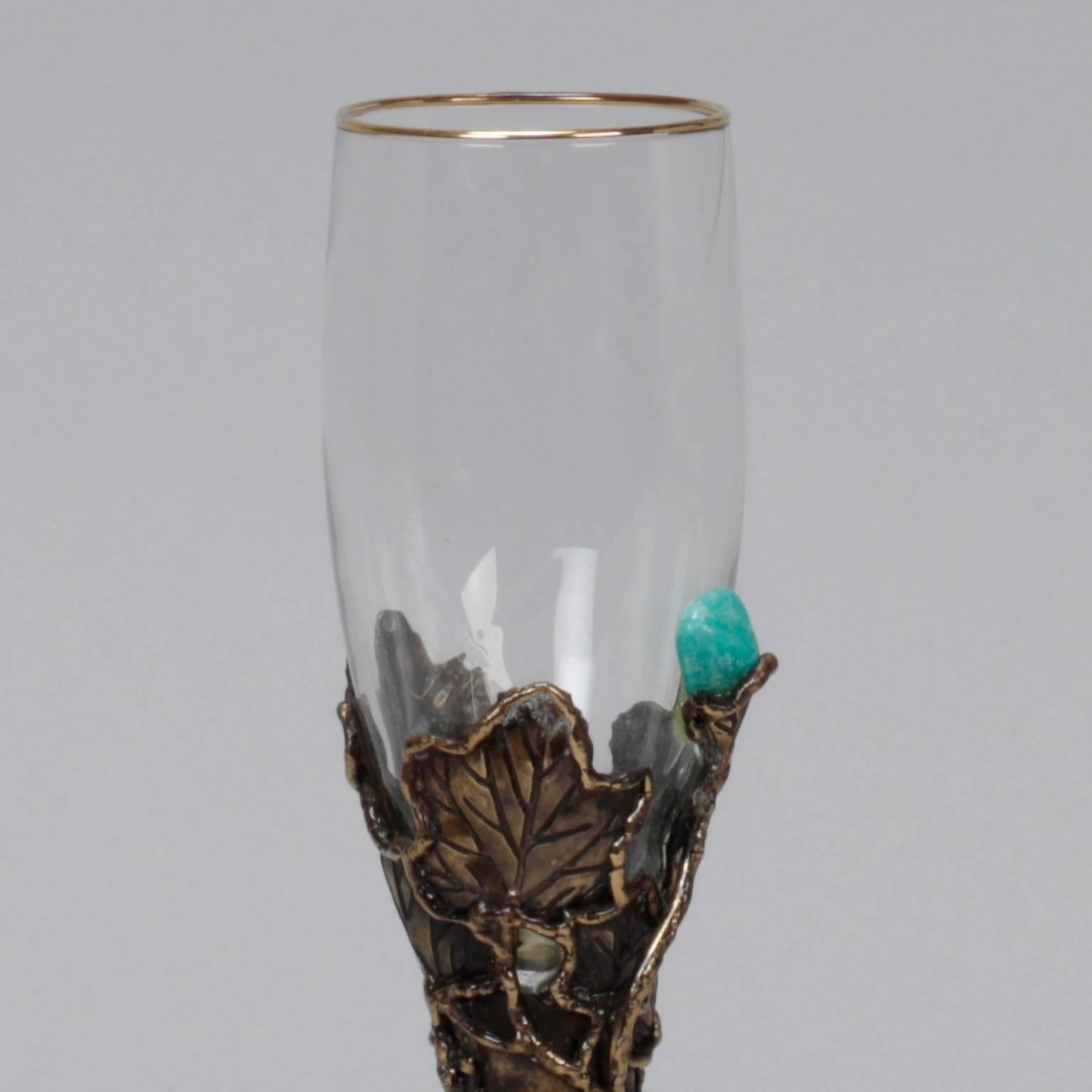 White wine glass with artisan made bronze tone metal surround with vines and leaves and turquoise stone accents, circa 1980s. Glass has gold rim and piece is marked 