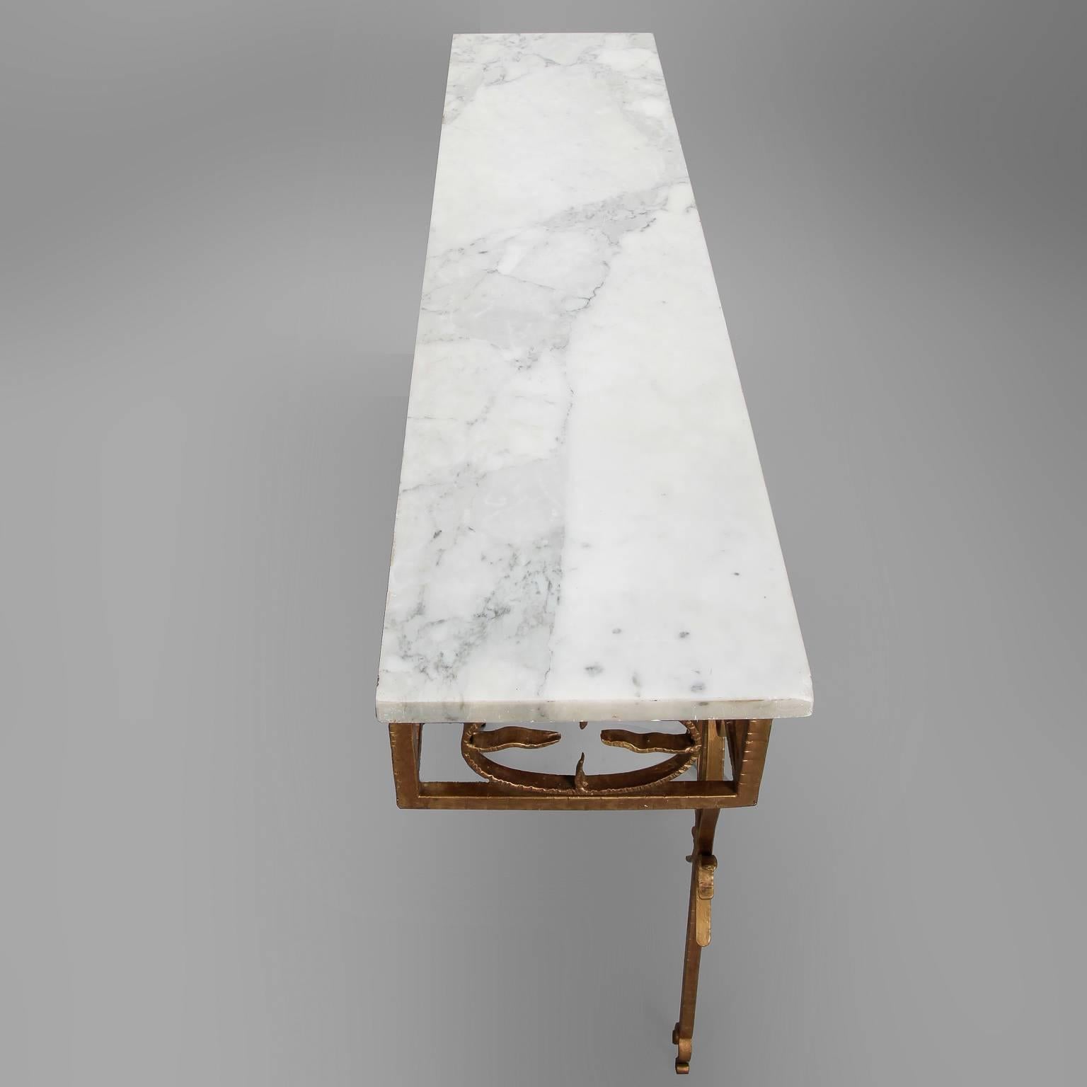 Wall hung console has gilt iron base with decorative scrolls and a white marble top, circa 1960s. Found in Italy. Unknown maker.

  