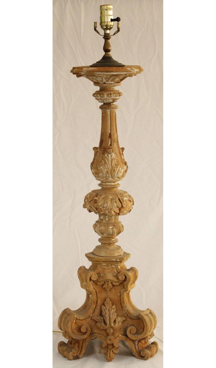 Single pricket stick, of carved wood, having a pickled wood finish, on tripartite base with scroll feet. Electrified.

Stock ID: D6973